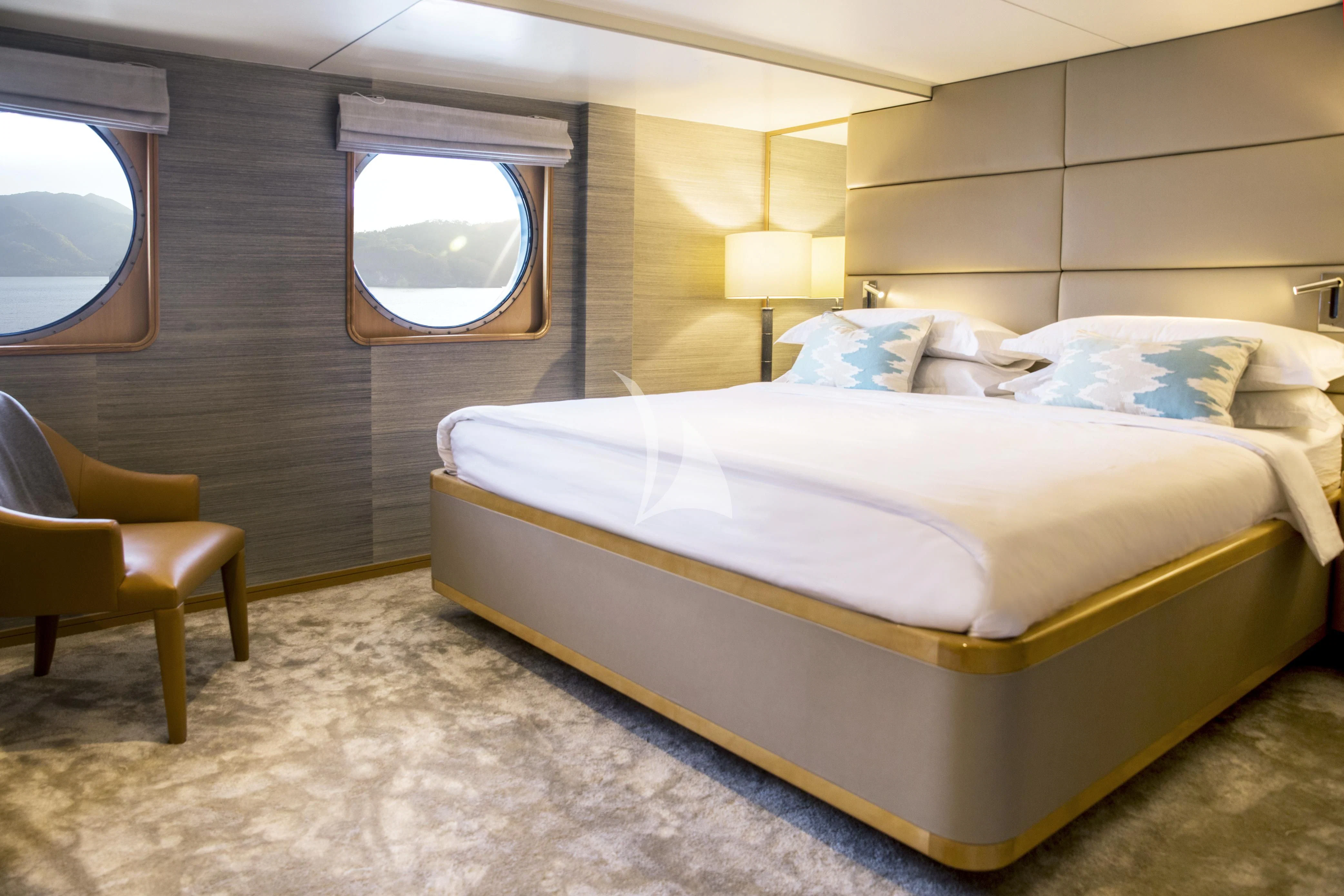 a room with a bed and a chair aboard AQUA BLU Yacht for Sale
