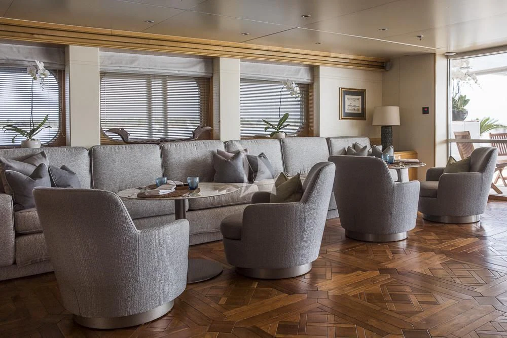 a living room with a couch and a table aboard AQUA BLU Yacht for Sale