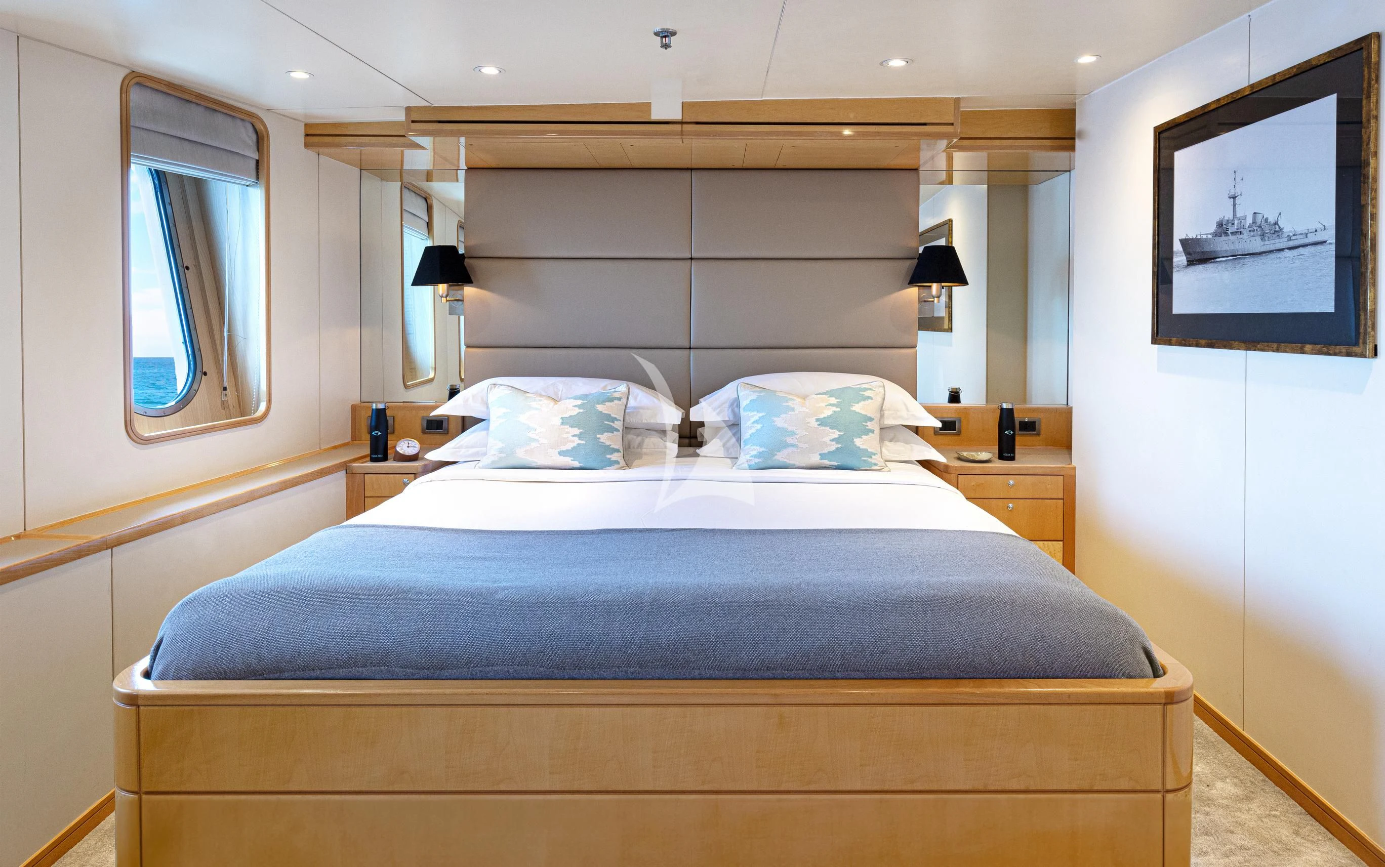 a bed with a blue comforter aboard AQUA BLU Yacht for Sale