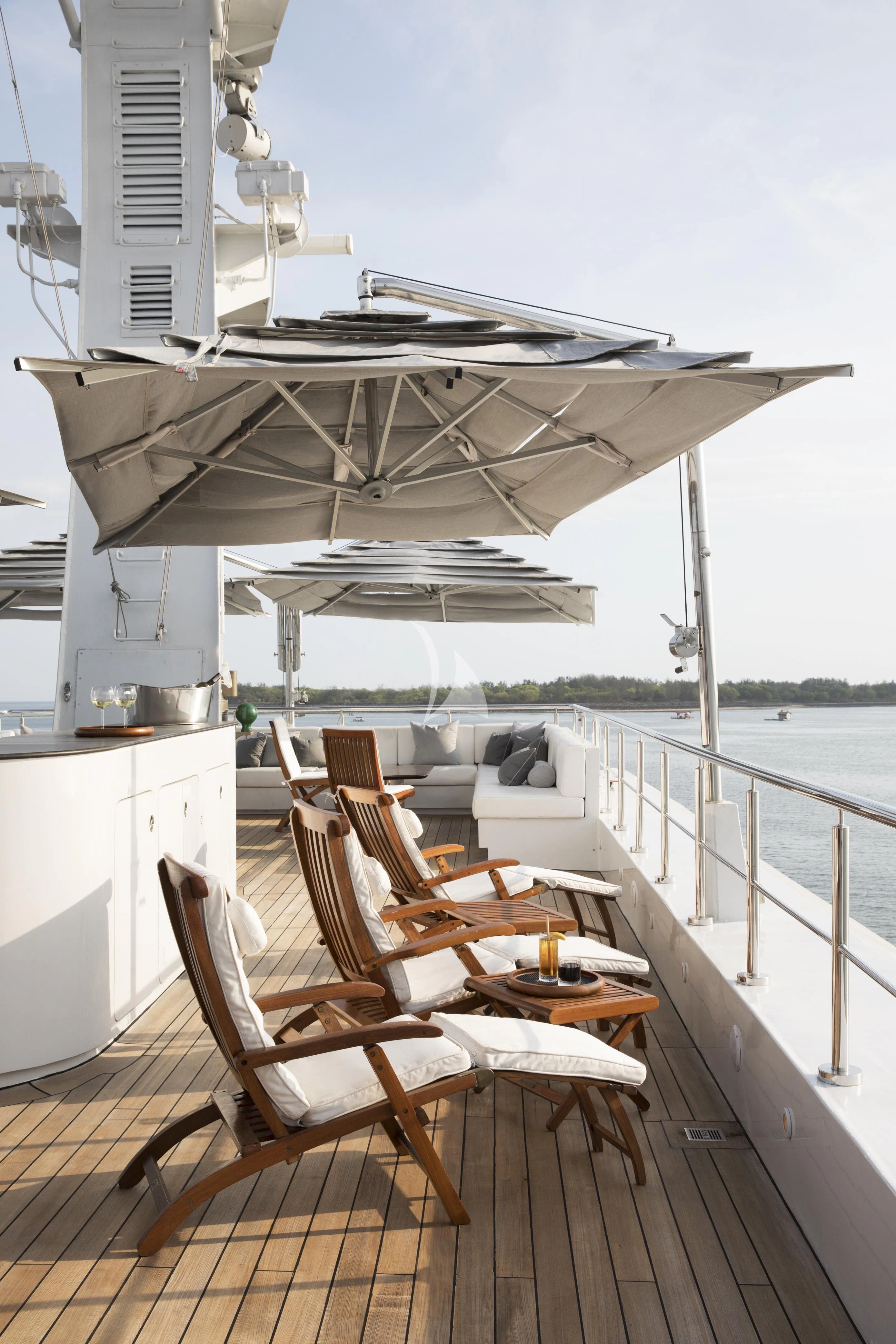 a deck with chairs and tables on it aboard AQUA BLU Yacht for Sale
