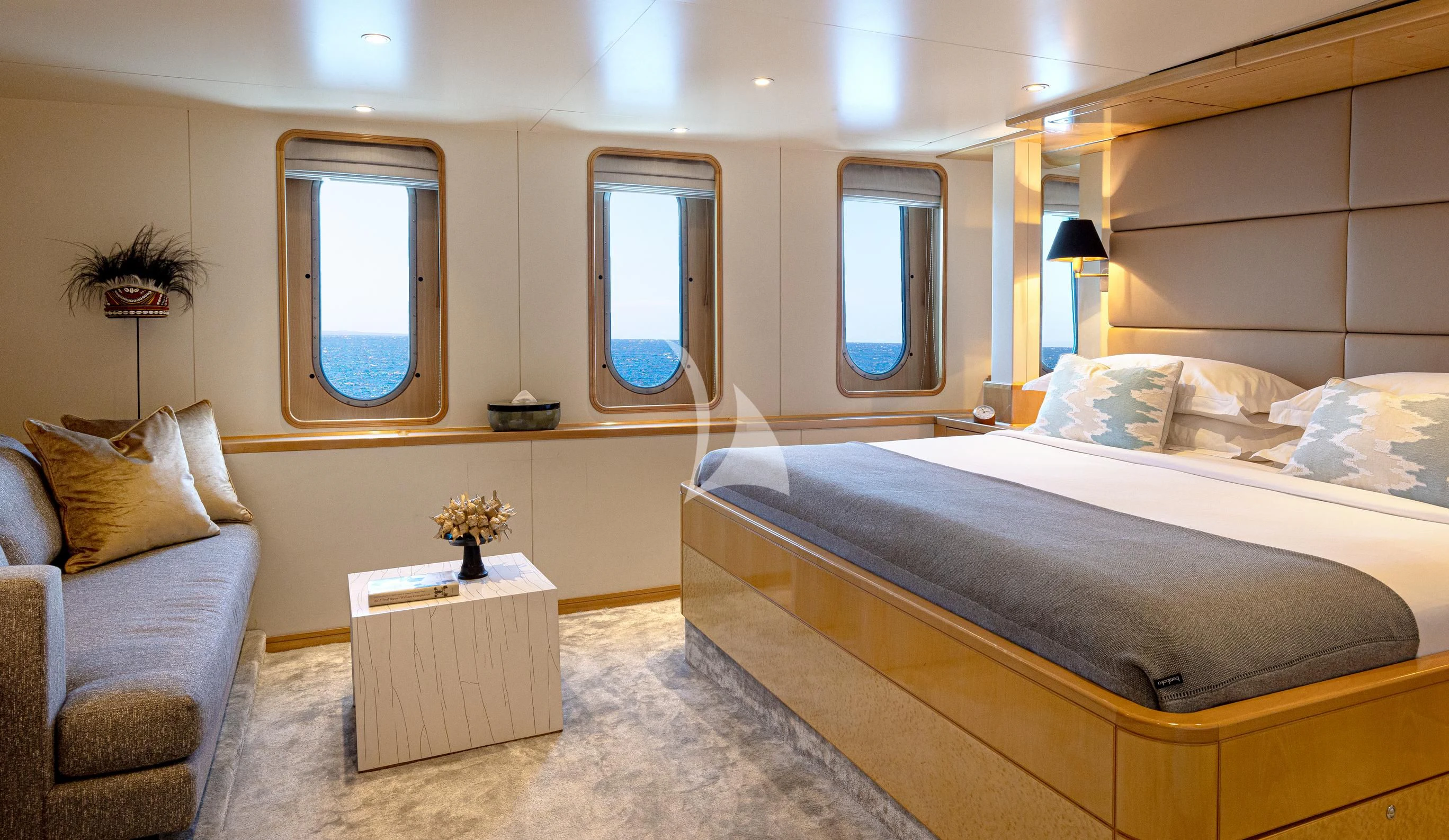 a bedroom with a bed and a chair aboard AQUA BLU Yacht for Sale