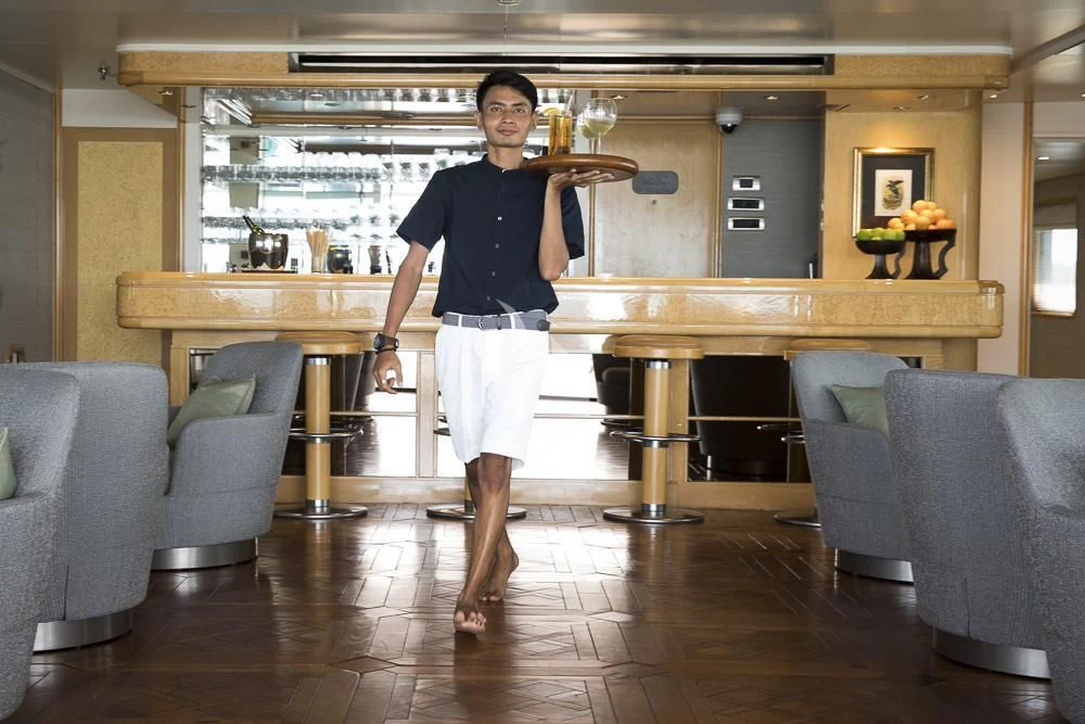 a person holding a large wooden spoon aboard AQUA BLU Yacht for Sale