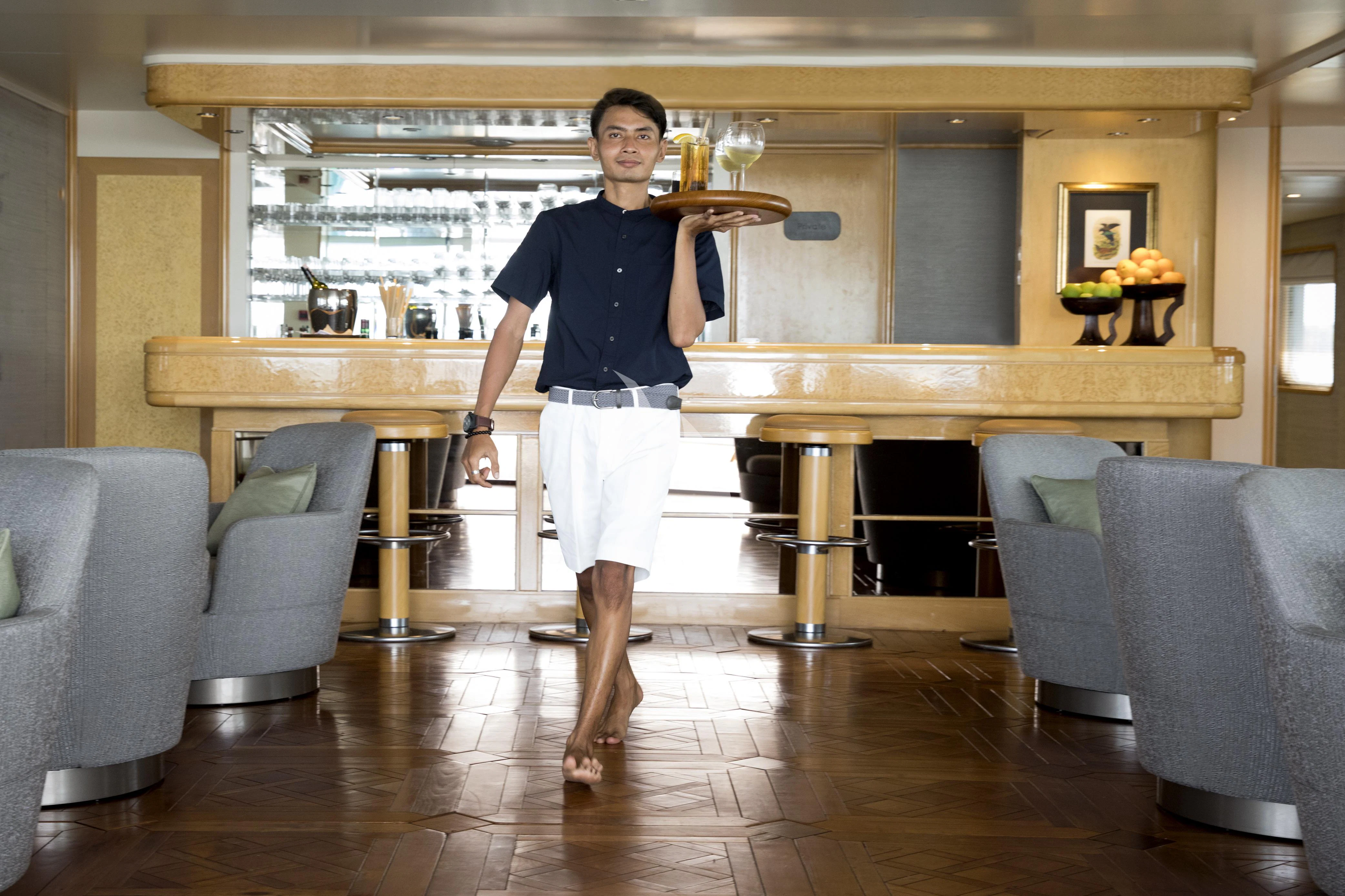 a person holding a large wooden spoon aboard AQUA BLU Yacht for Sale