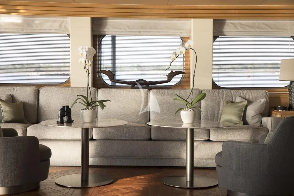 a living room with a couch and a coffee table aboard AQUA BLU Yacht for Sale