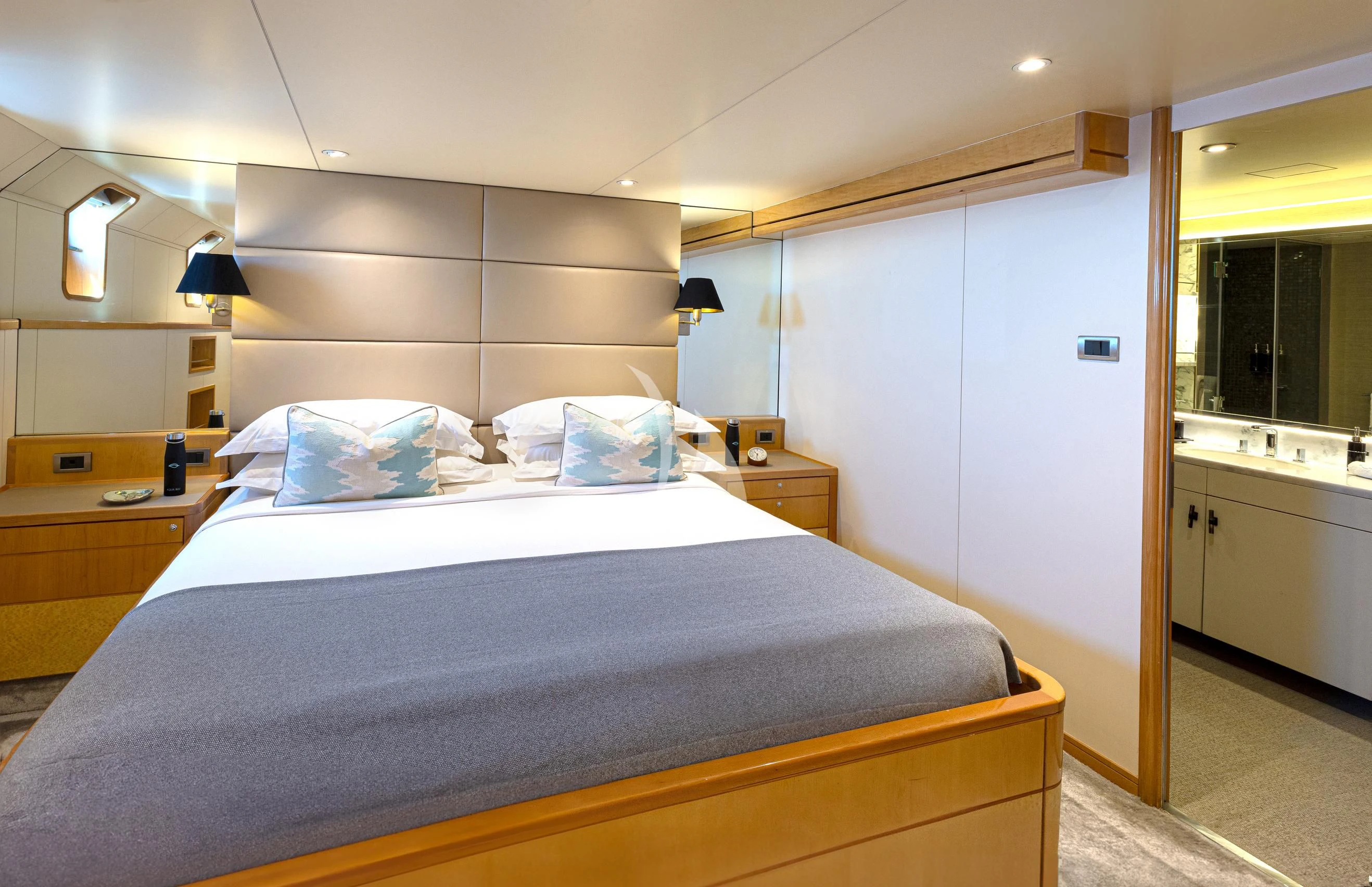 a bed with a blue comforter aboard AQUA BLU Yacht for Sale