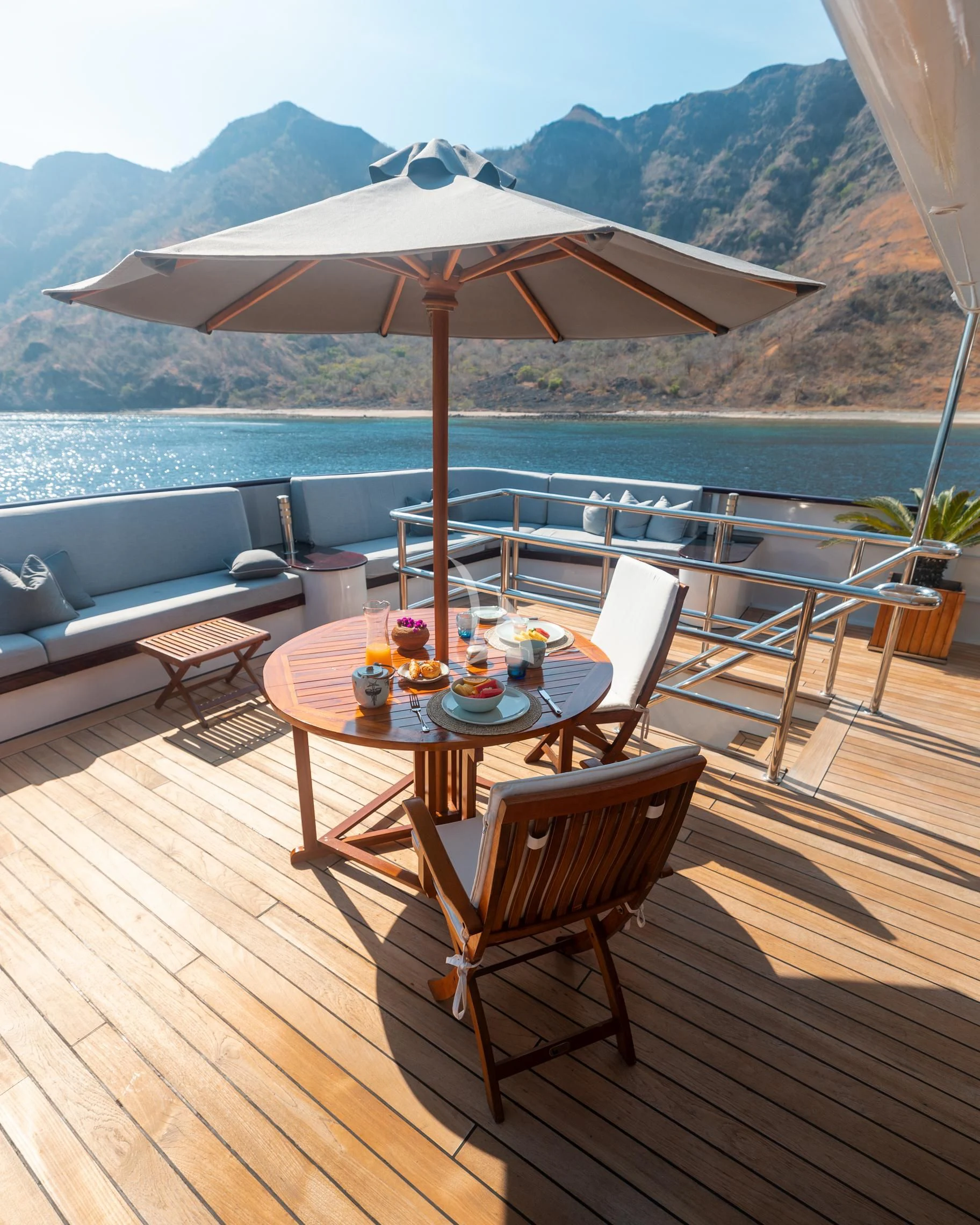 a table and chairs on a deck aboard AQUA BLU Yacht for Sale