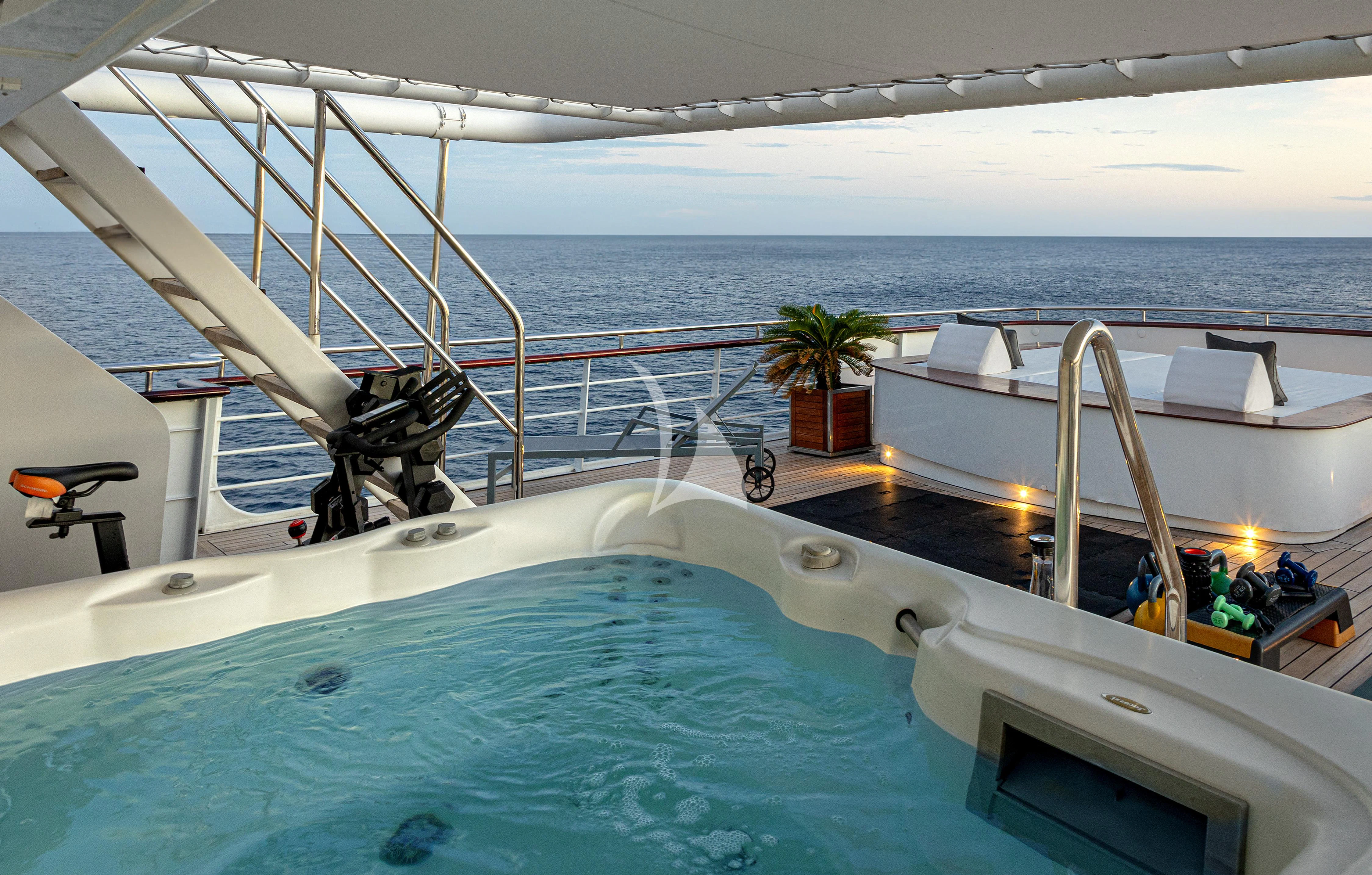 a boat with a motor and a satellite dish on the deck aboard AQUA BLU Yacht for Sale