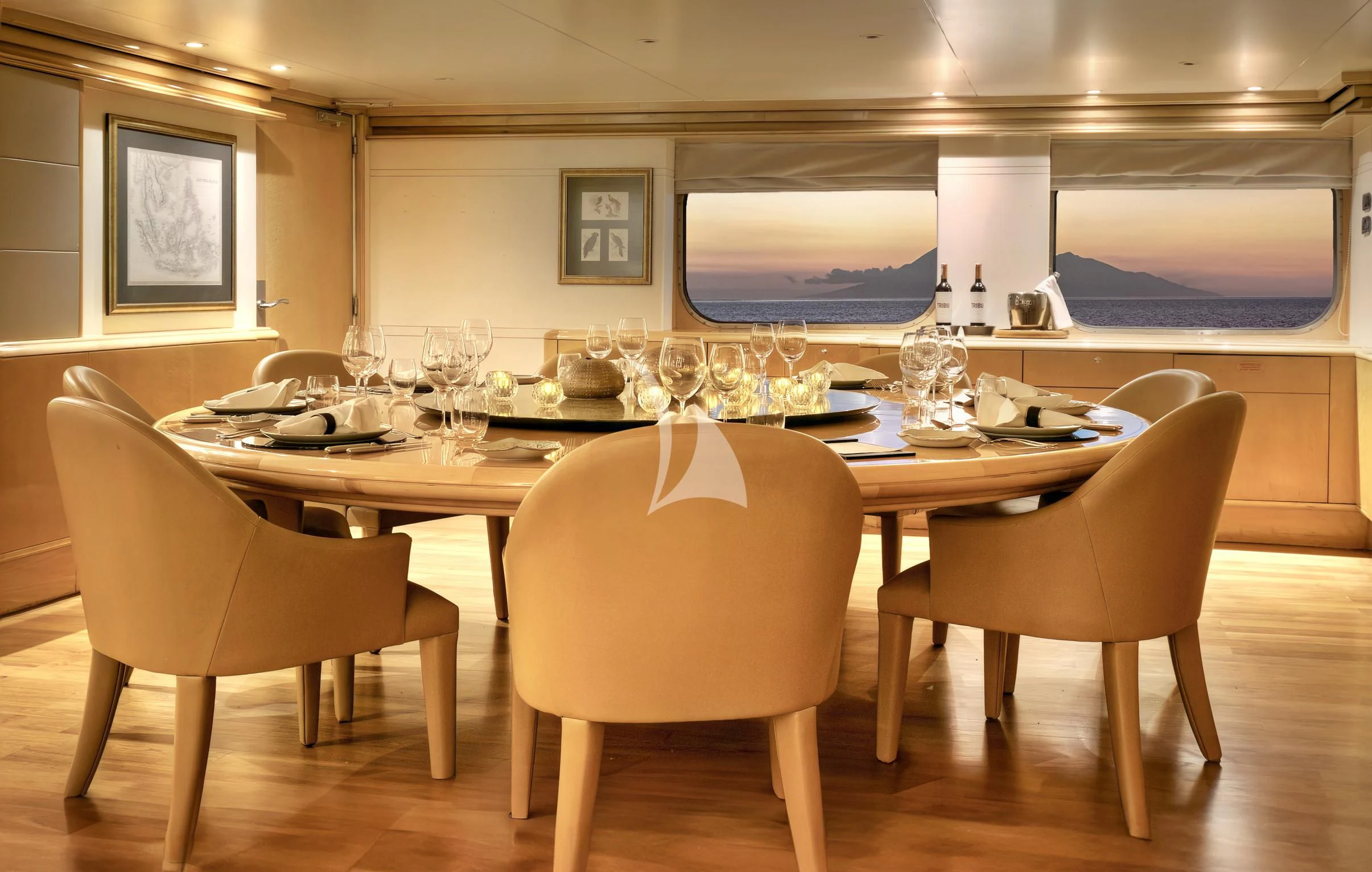 a large table with chairs and a large screen aboard AQUA BLU Yacht for Sale