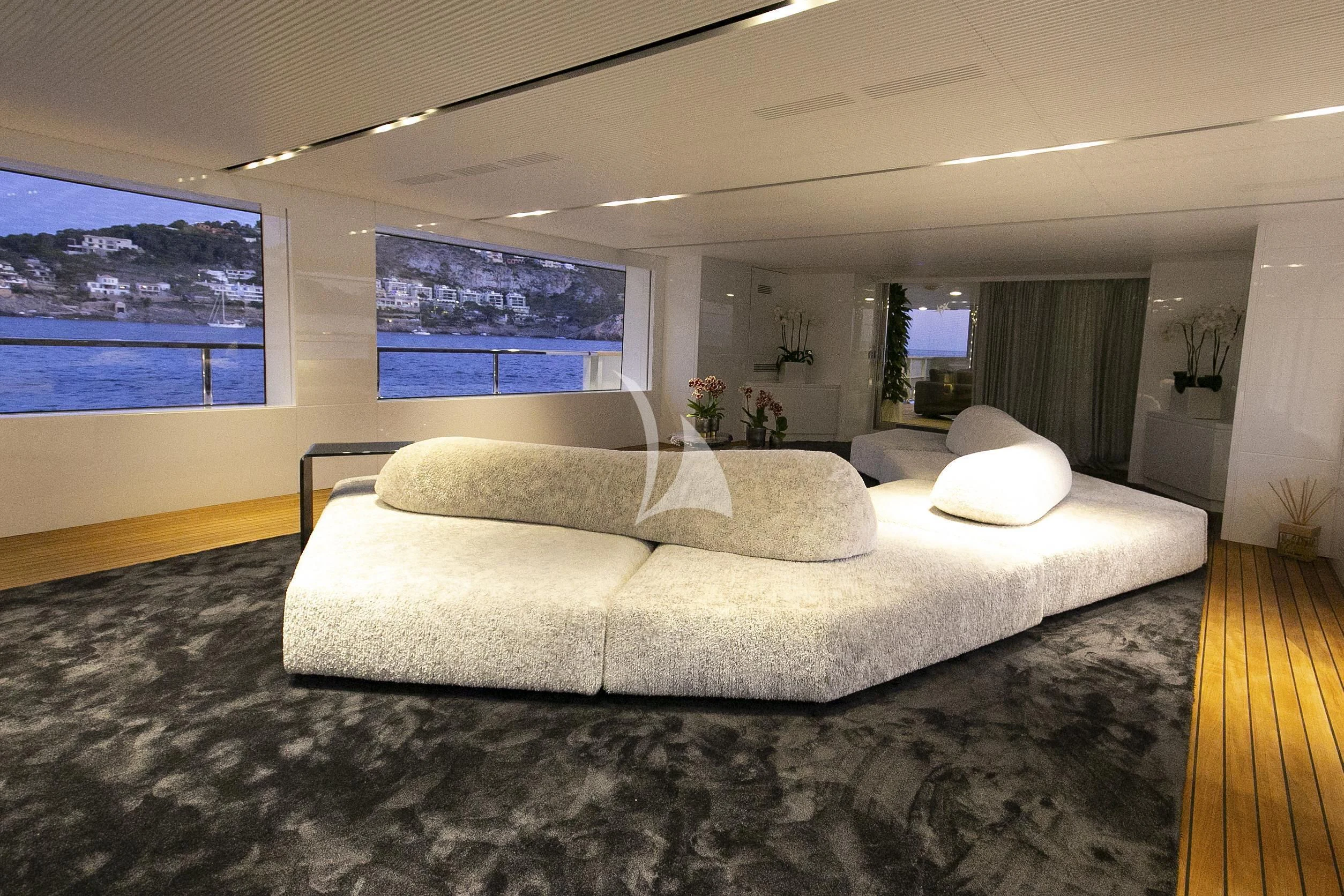 a large living room with a large window aboard R23 Yacht for Charter