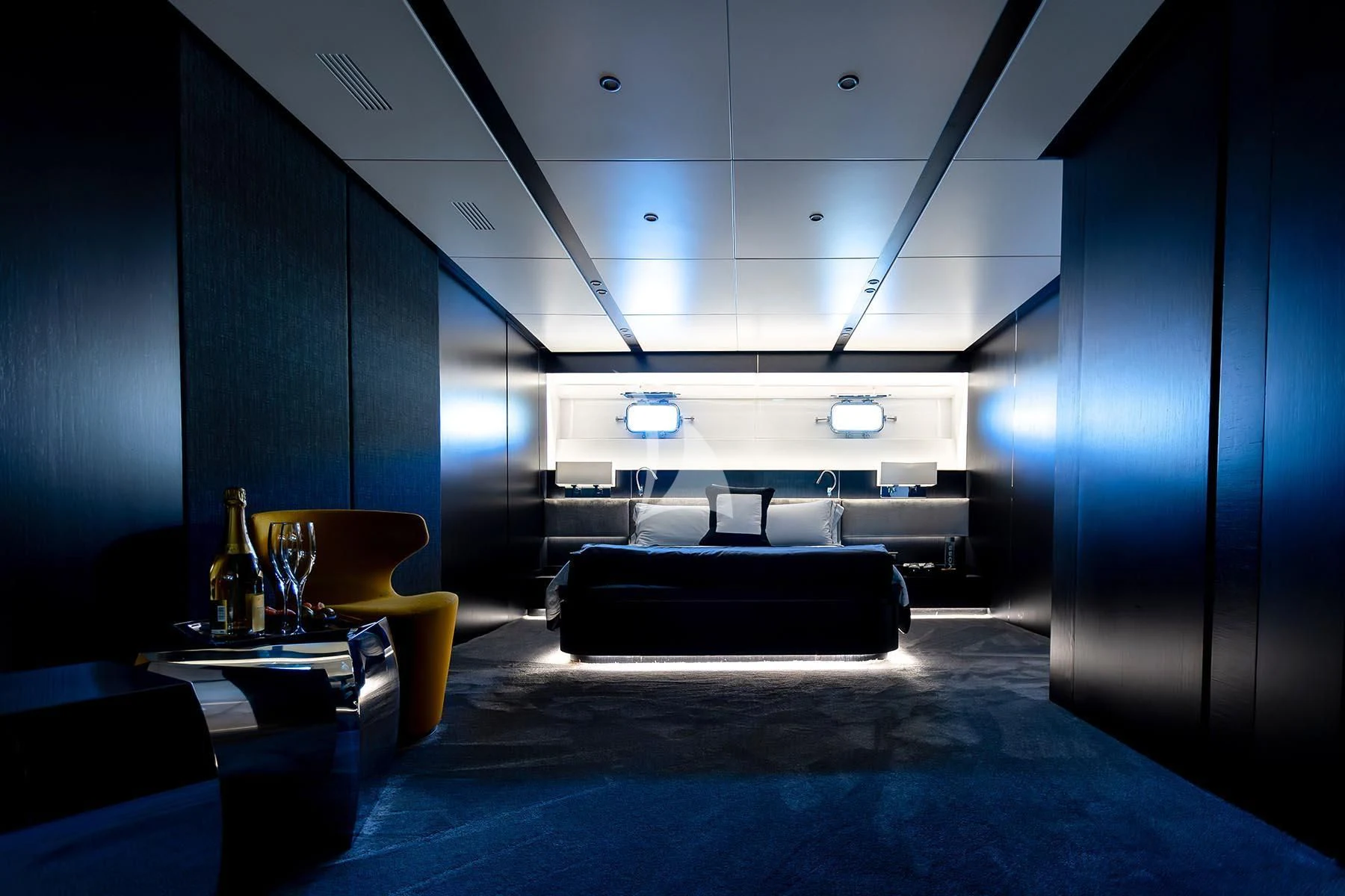 a room with a bed and a table aboard R23 Yacht for Charter