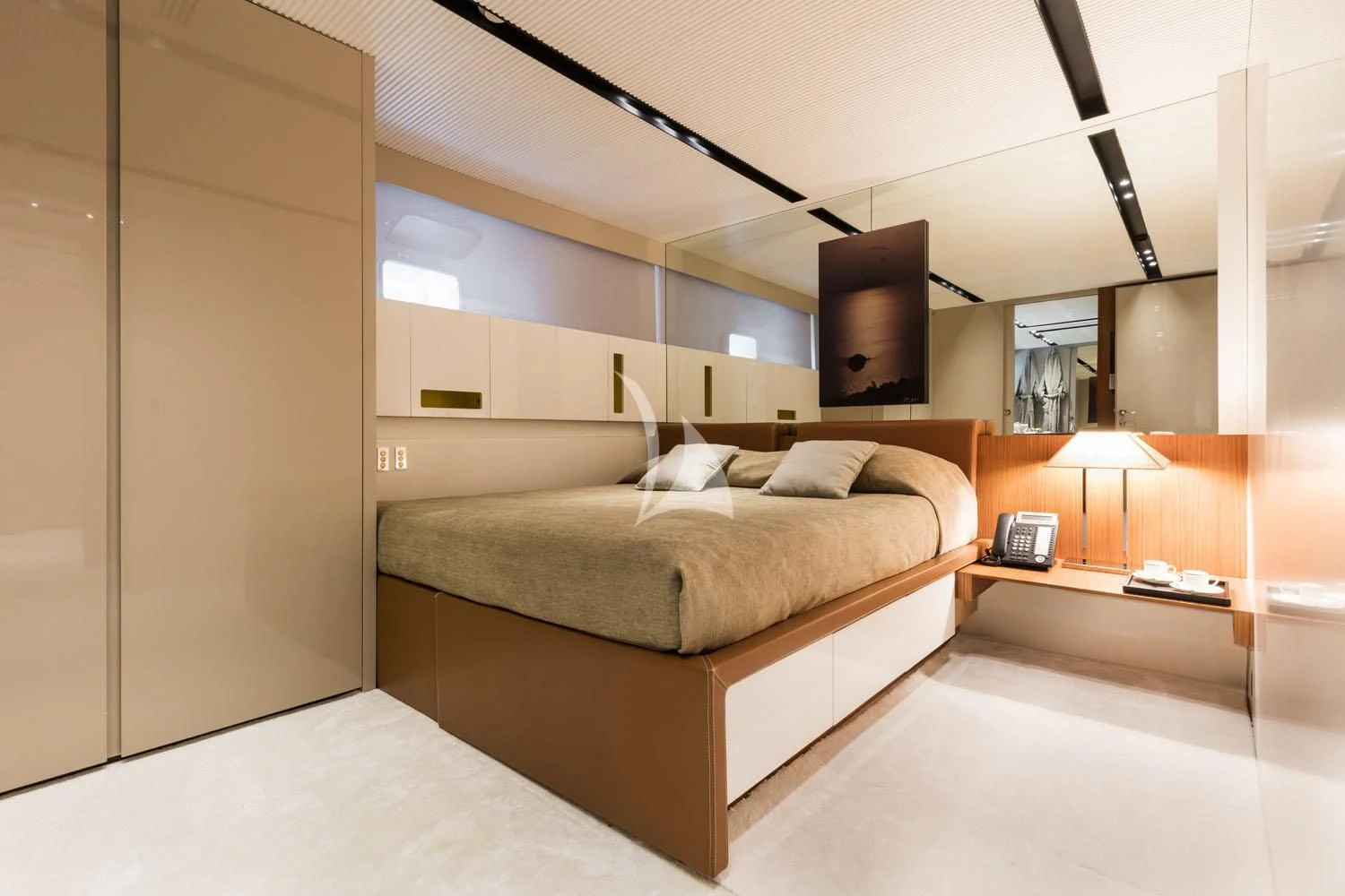 a bedroom with a bed and a desk aboard R23 Yacht for Charter
