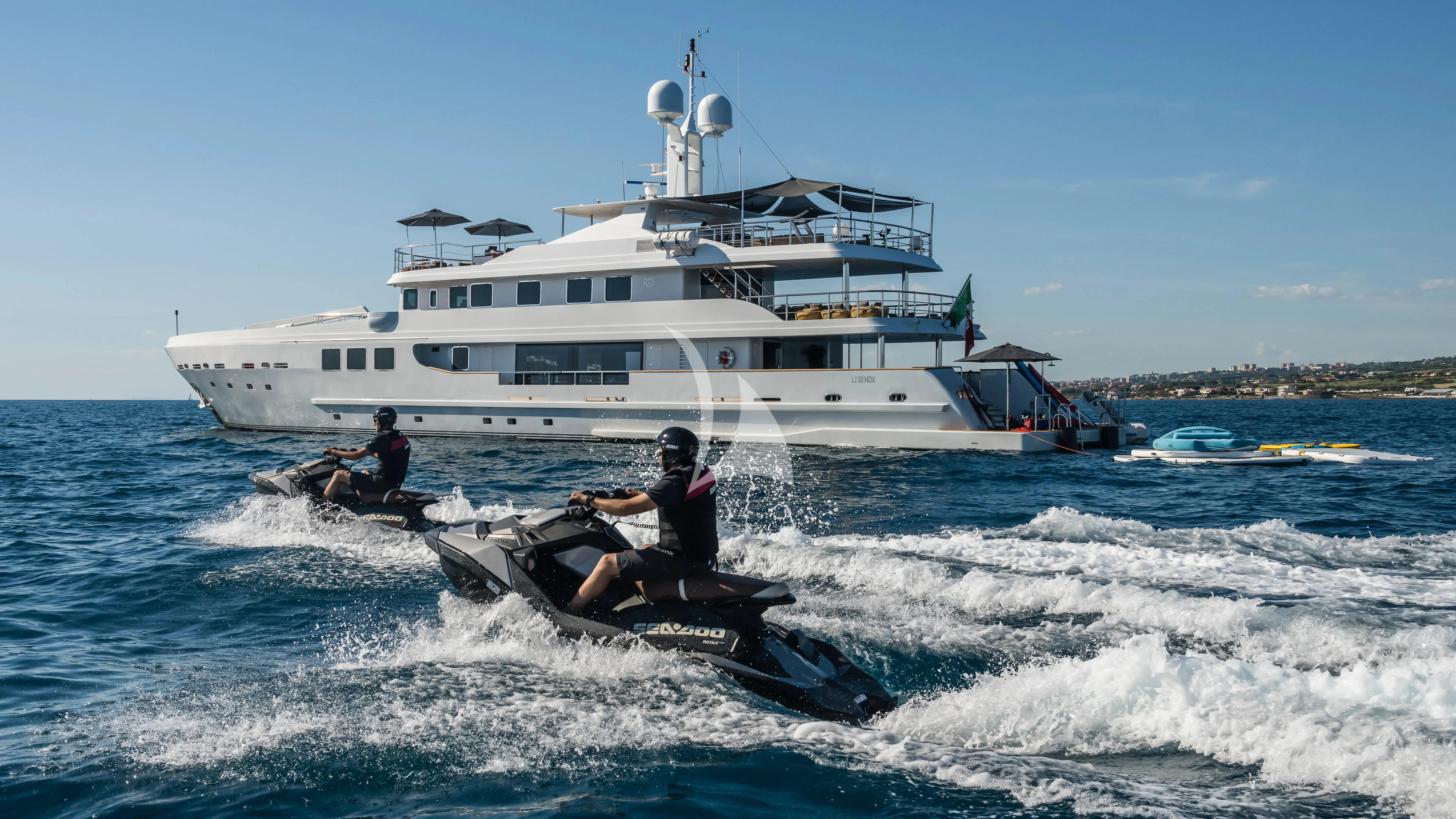 a boat in the water with a boat in the background aboard R23 Yacht for Charter