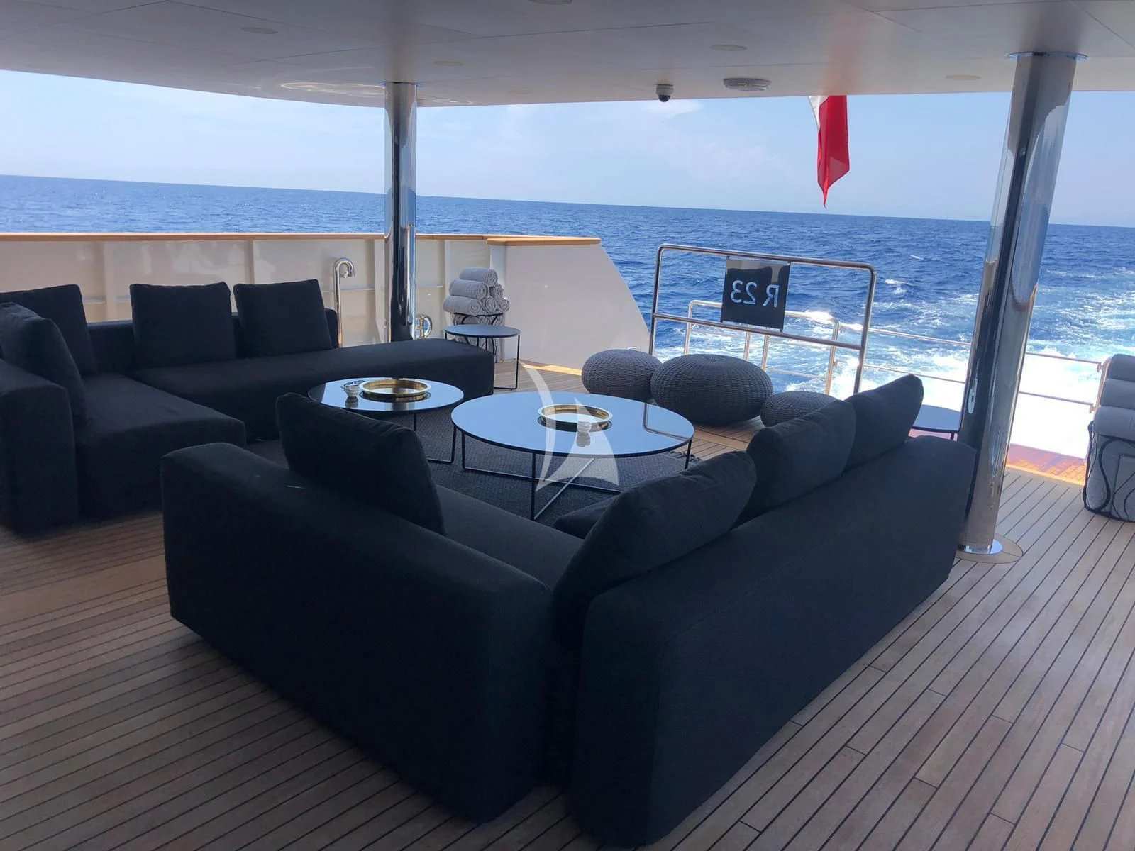 a living room with a large balcony aboard R23 Yacht for Charter