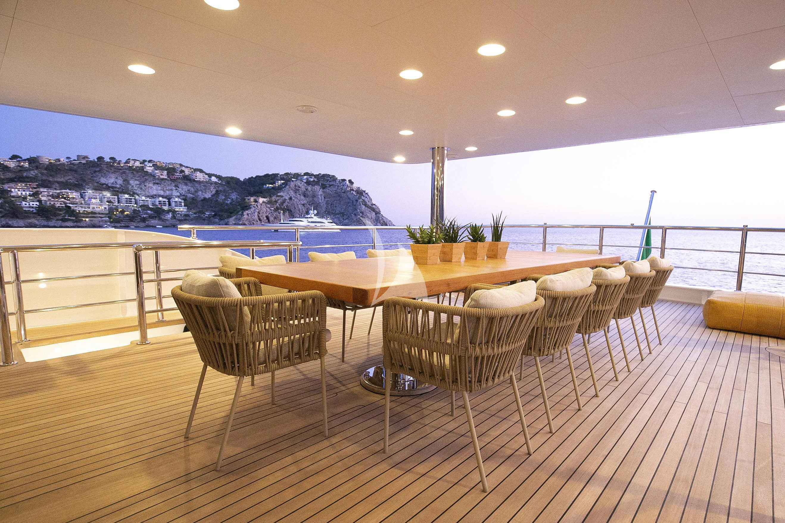 a table and chairs on a deck aboard R23 Yacht for Charter