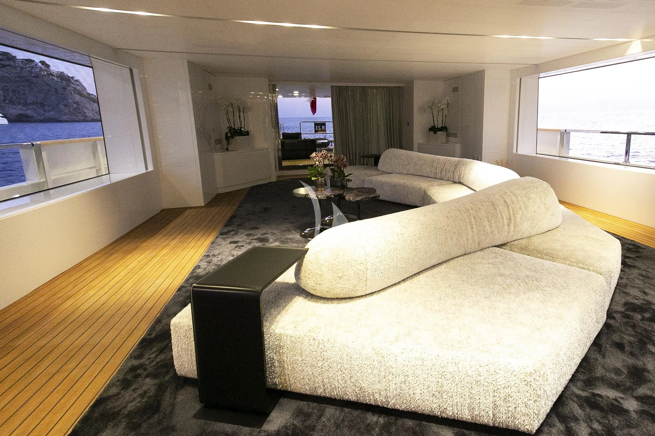 a living room with couches aboard R23 Yacht for Charter