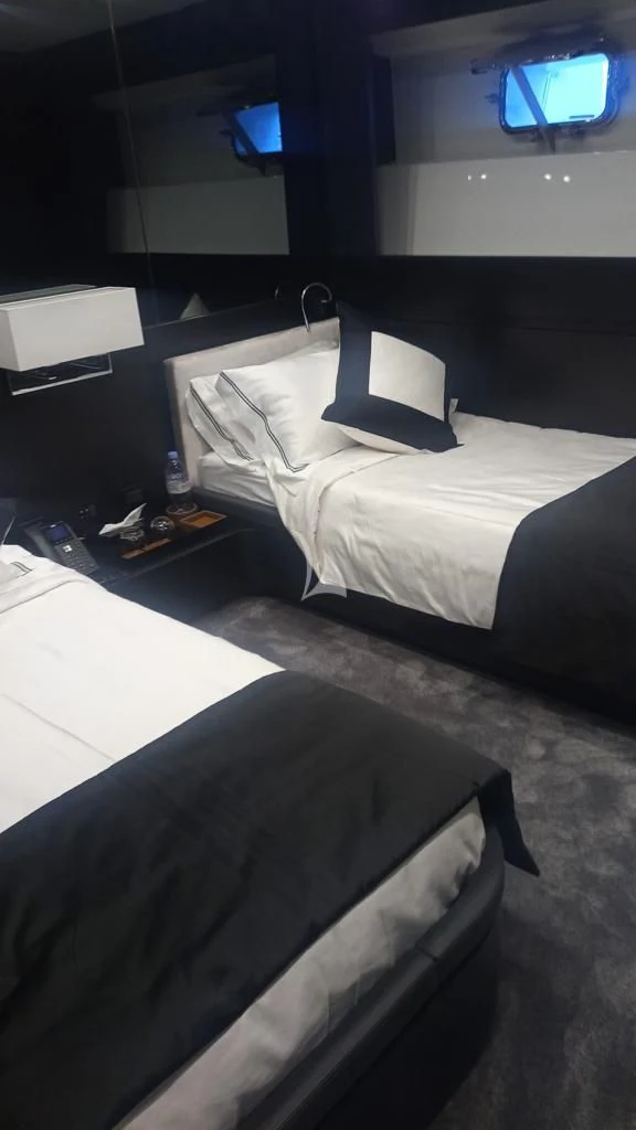 a room with two beds aboard R23 Yacht for Charter