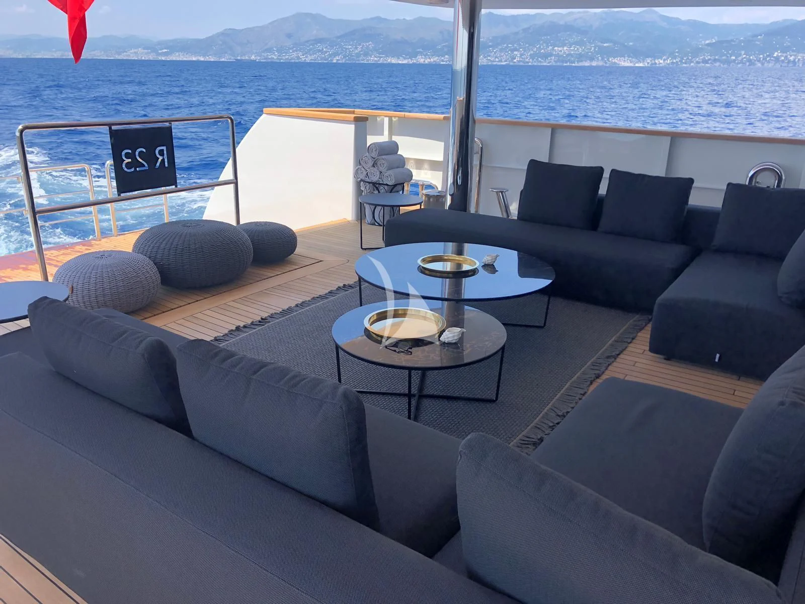 a living room with a large body of water and a large window aboard R23 Yacht for Charter