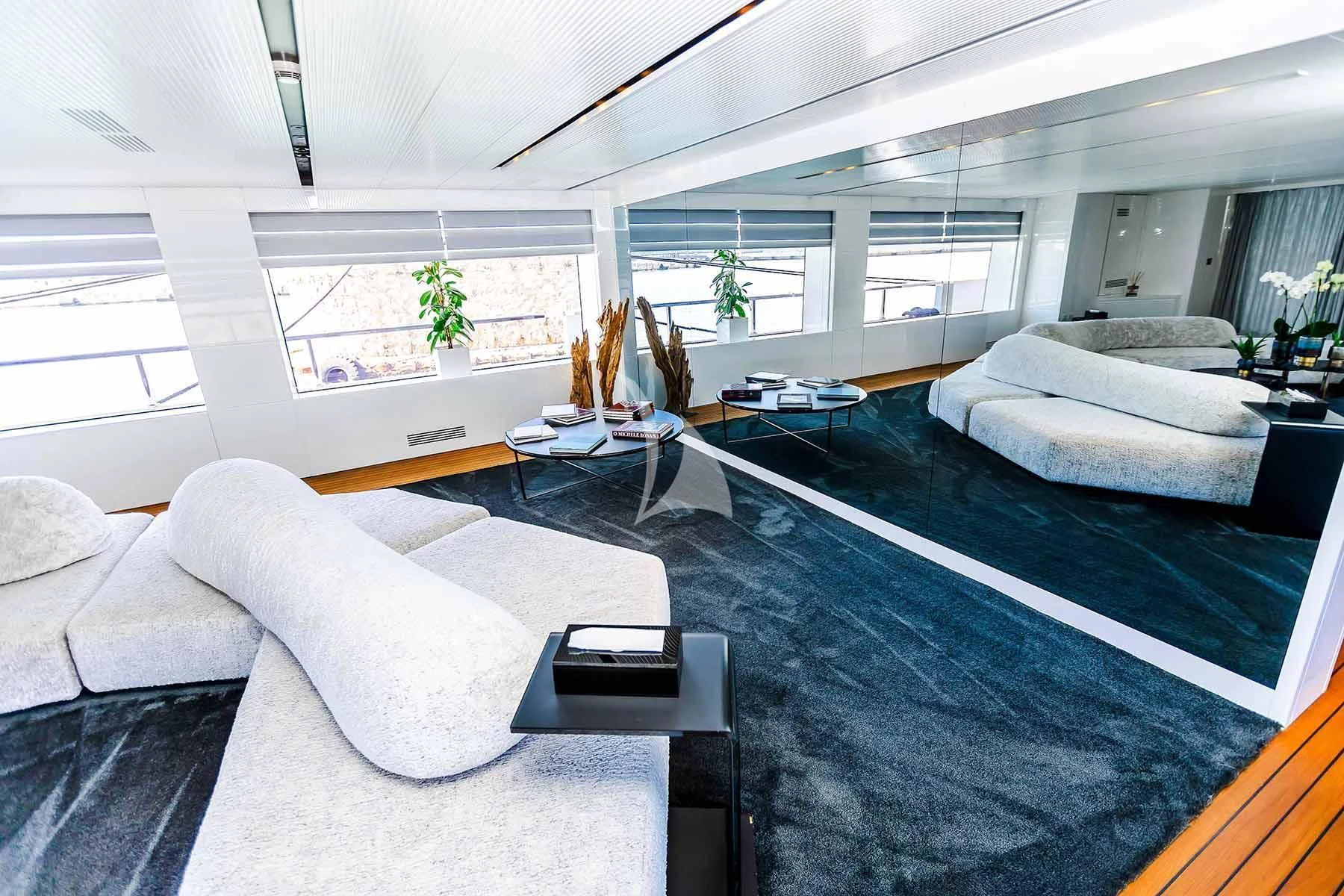 a room with couches and a table aboard R23 Yacht for Charter