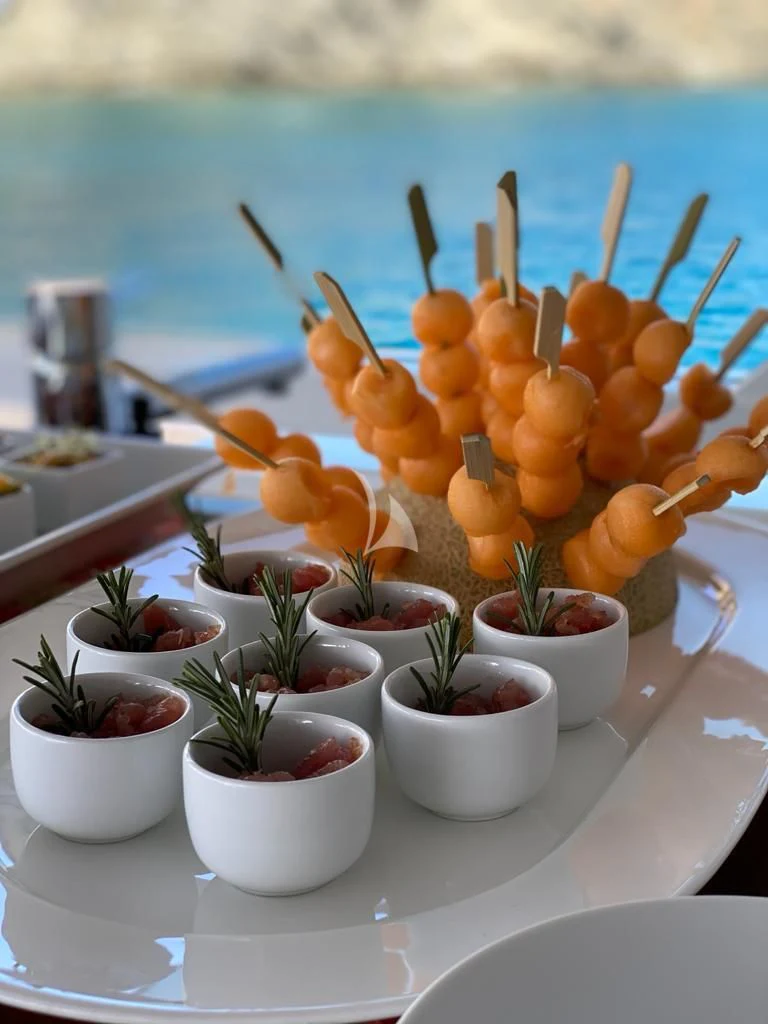 a plate of oranges and a plant on a table aboard R23 Yacht for Charter