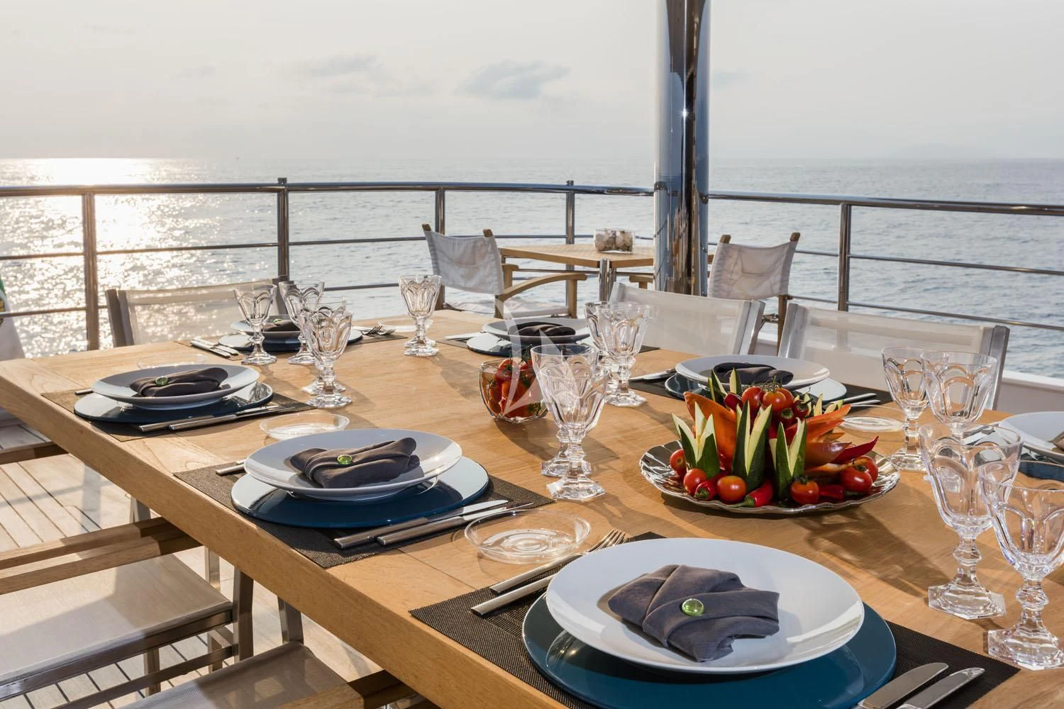 a table with plates and glasses on it aboard R23 Yacht for Charter