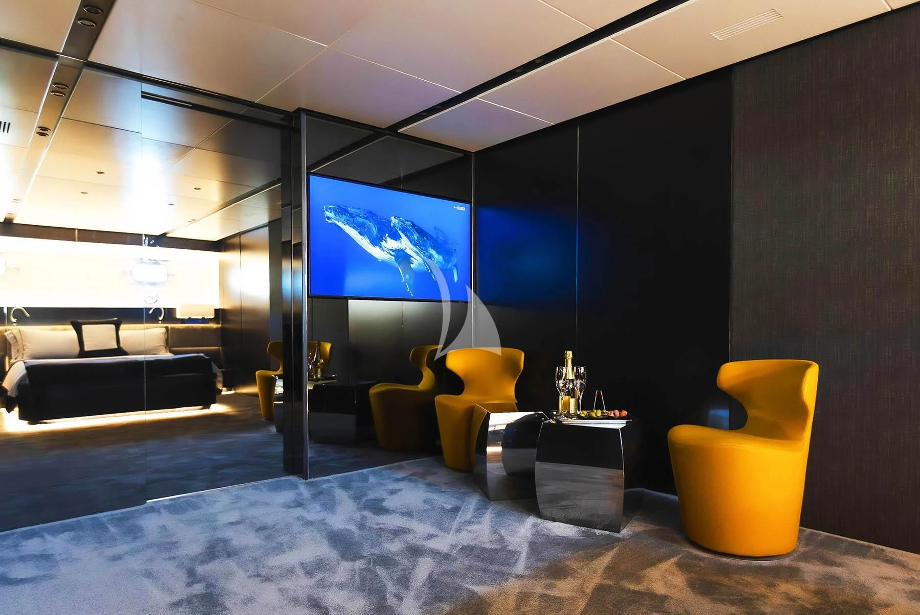 a room with a large screen aboard R23 Yacht for Charter