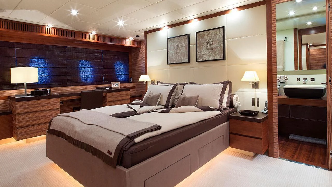 a hotel room with a bed and a large mirror aboard ALEON Yacht for Sale
