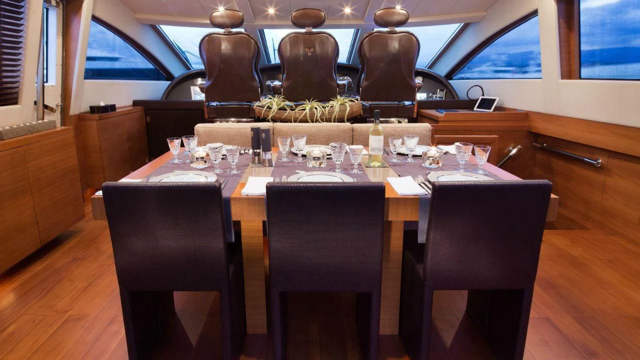 a table with wine glasses aboard ALEON Yacht for Sale