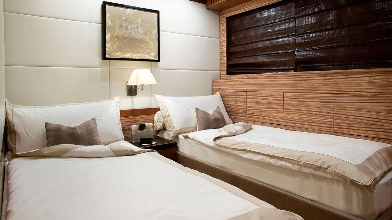 a couple of beds in a hotel room aboard ALEON Yacht for Sale