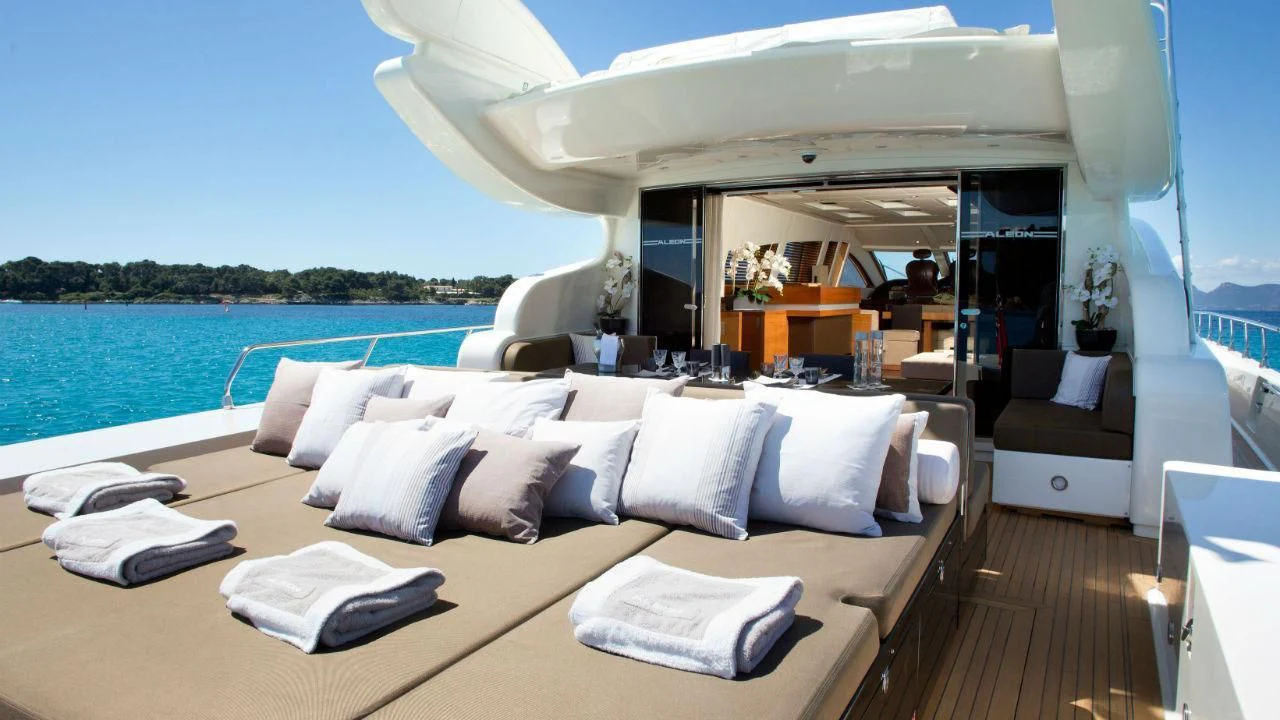 a large white lounge chair with a large white bed and a large body of water aboard ALEON Yacht for Sale