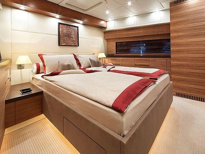 a bed with red pillows aboard ALEON Yacht for Sale