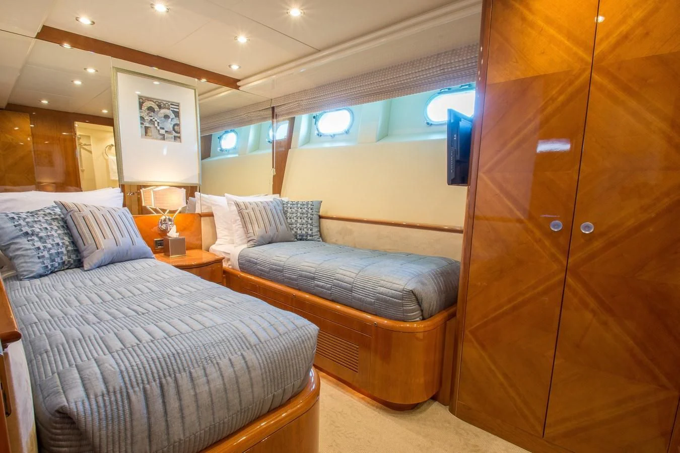 a room with a bed and a wood cabinet aboard NO NAME AZIMUT 100 JUMBO Yacht for Sale