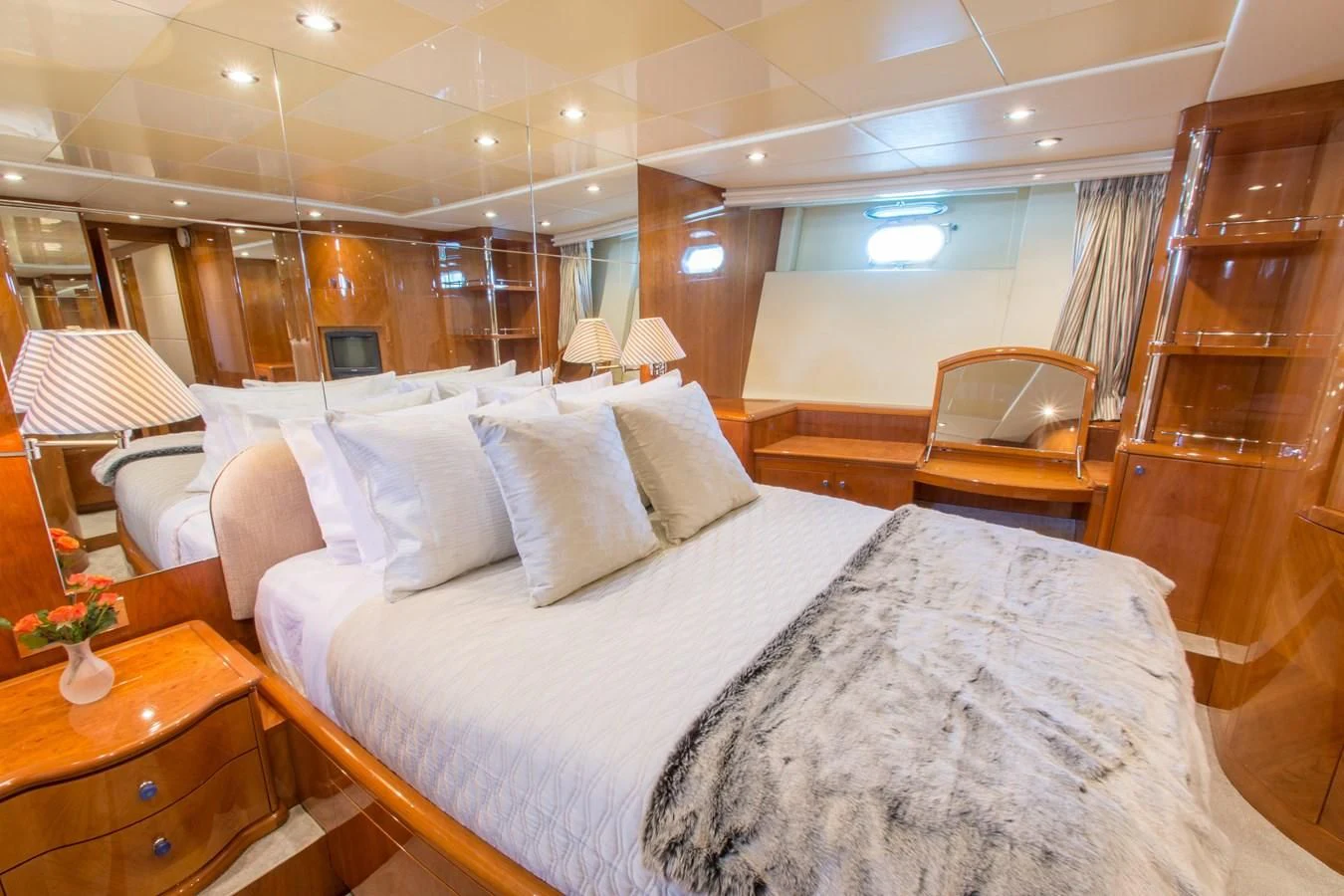 a room with a bed and a chair aboard NO NAME AZIMUT 100 JUMBO Yacht for Sale