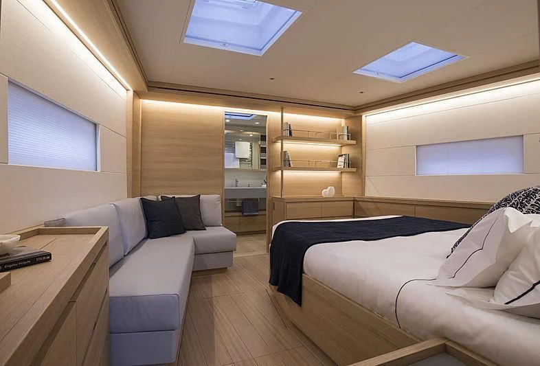 a room with a bed and a desk aboard POWER OF 2 Yacht for Sale