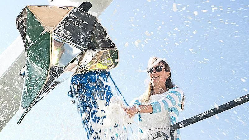 a person in a white hat and sunglasses holding a ski aboard POWER OF 2 Yacht for Sale