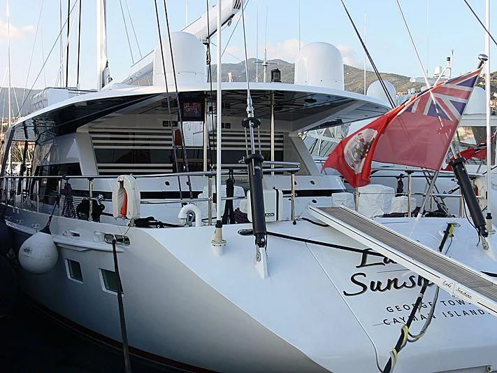 a white boat with red and black sails aboard LADY SUNSHINE Yacht for Sale