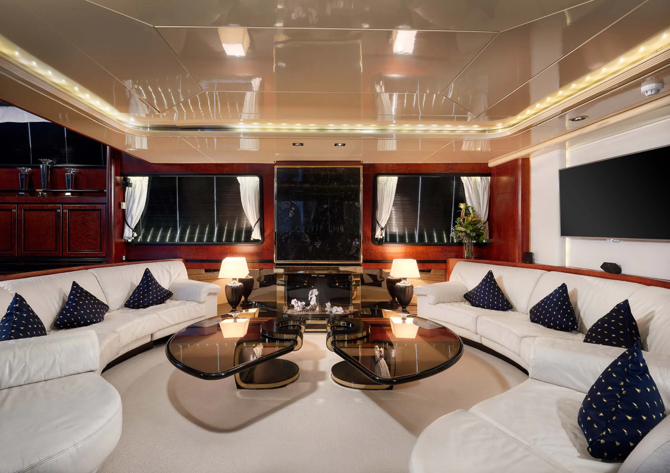 a large living room with a large white couch and a large television aboard LADY SUNSHINE Yacht for Sale