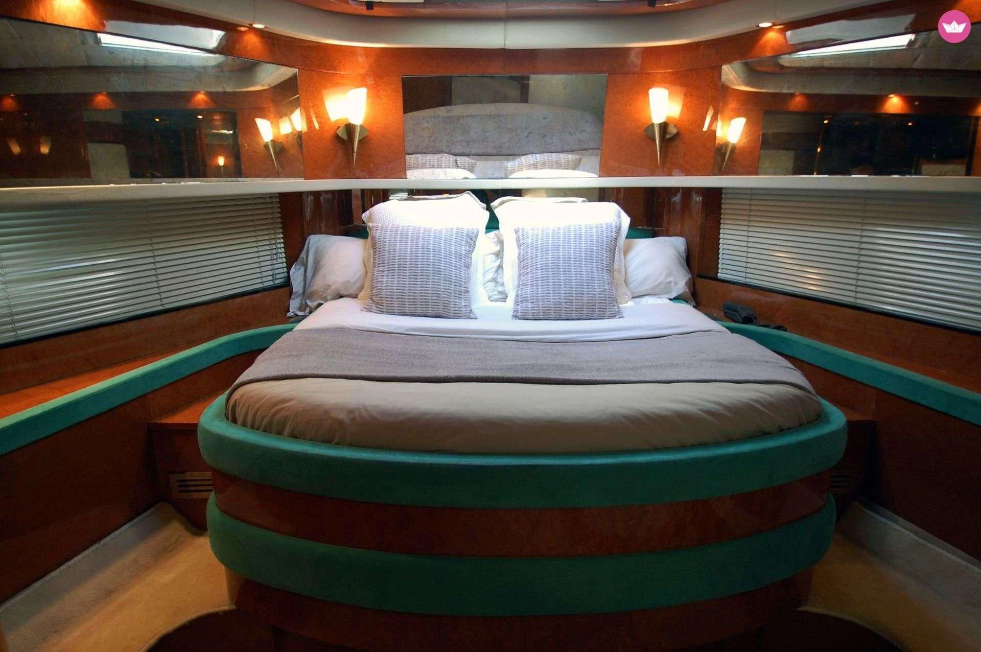 a bed with a blue comforter aboard LEIGH Yacht for Sale
