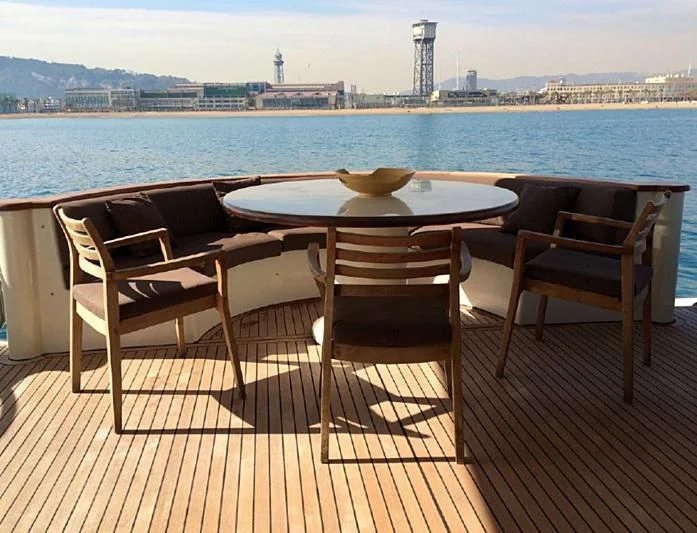 a table and chairs on a deck overlooking a body of water aboard LEIGH Yacht for Sale