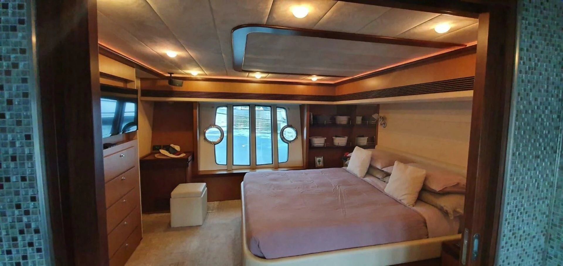 a bedroom with a bed and a window aboard SEDROP Yacht for Sale