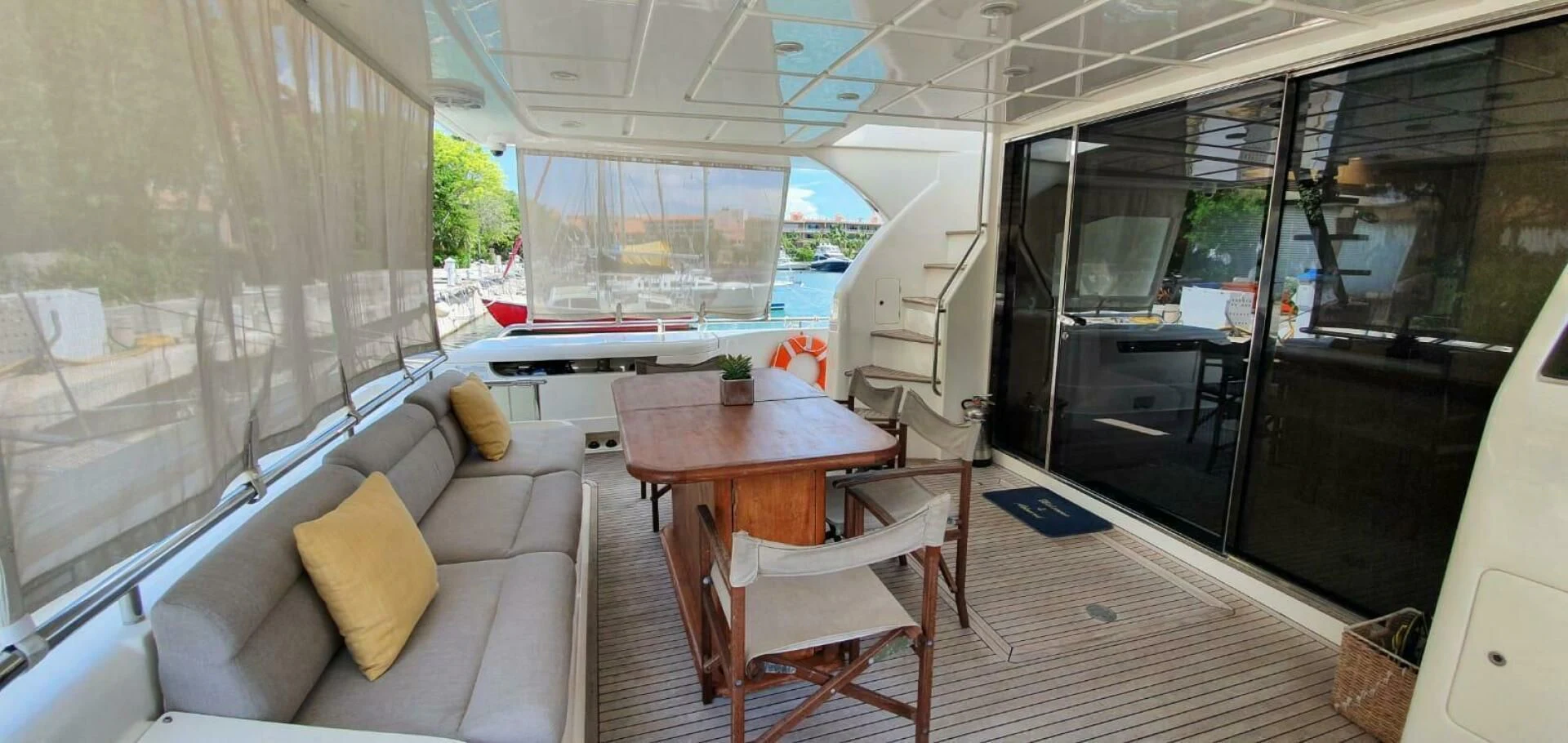 a living room with a table and couches aboard SEDROP Yacht for Sale