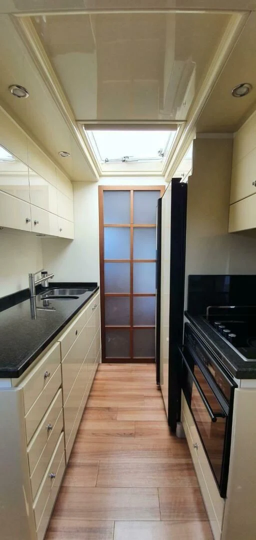 a kitchen with a wood floor aboard SEDROP Yacht for Sale