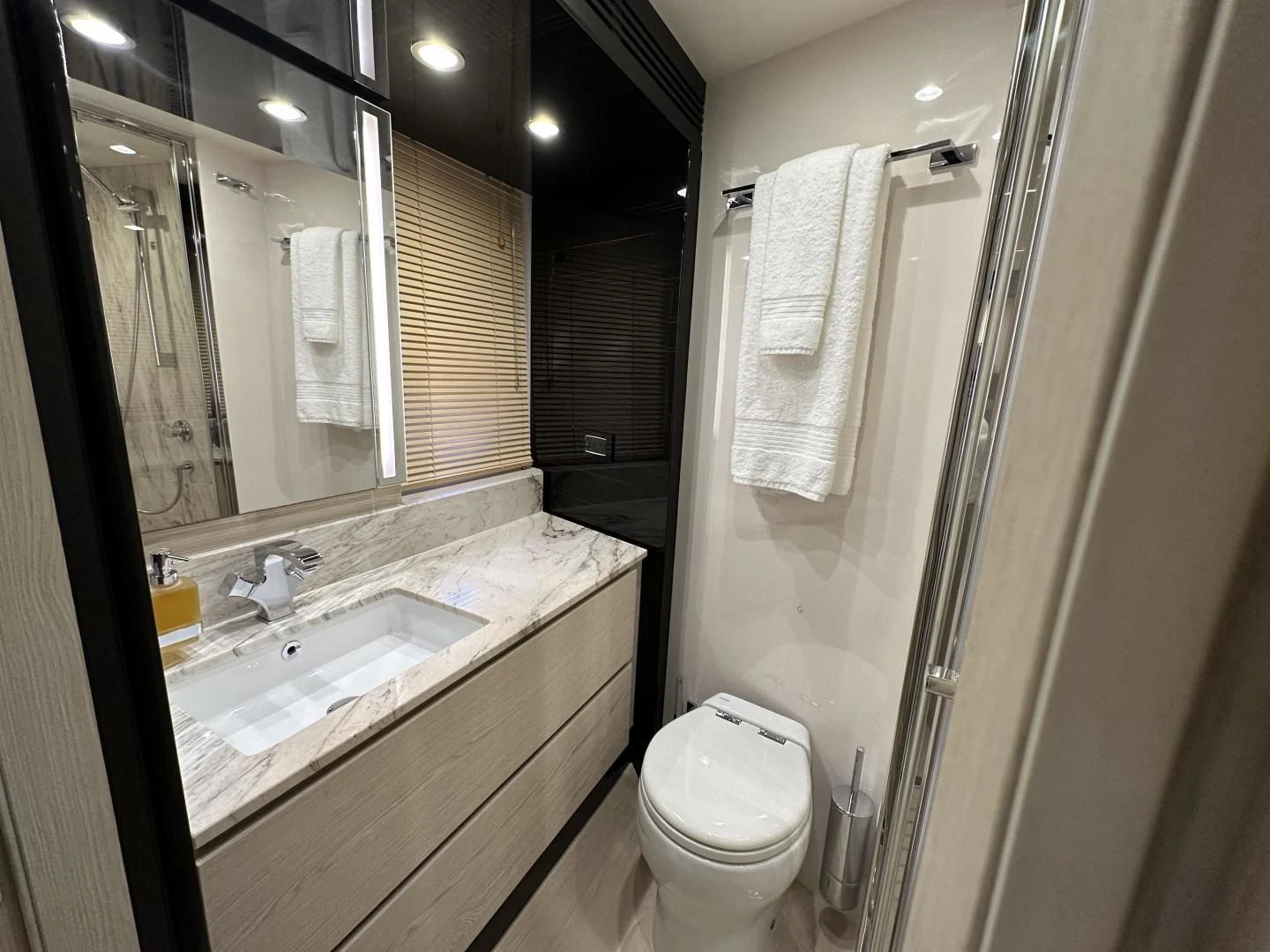 a bathroom with a sink toilet and a mirror aboard VELOCITY Yacht for Sale