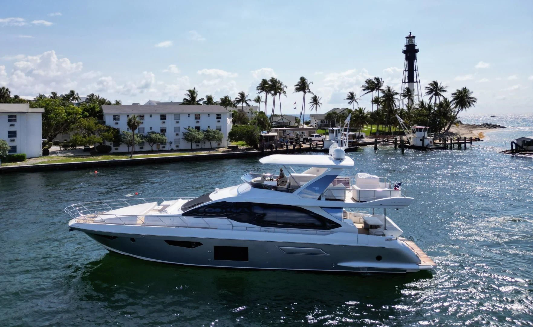 a white yacht in a harbor aboard VELOCITY Yacht for Sale