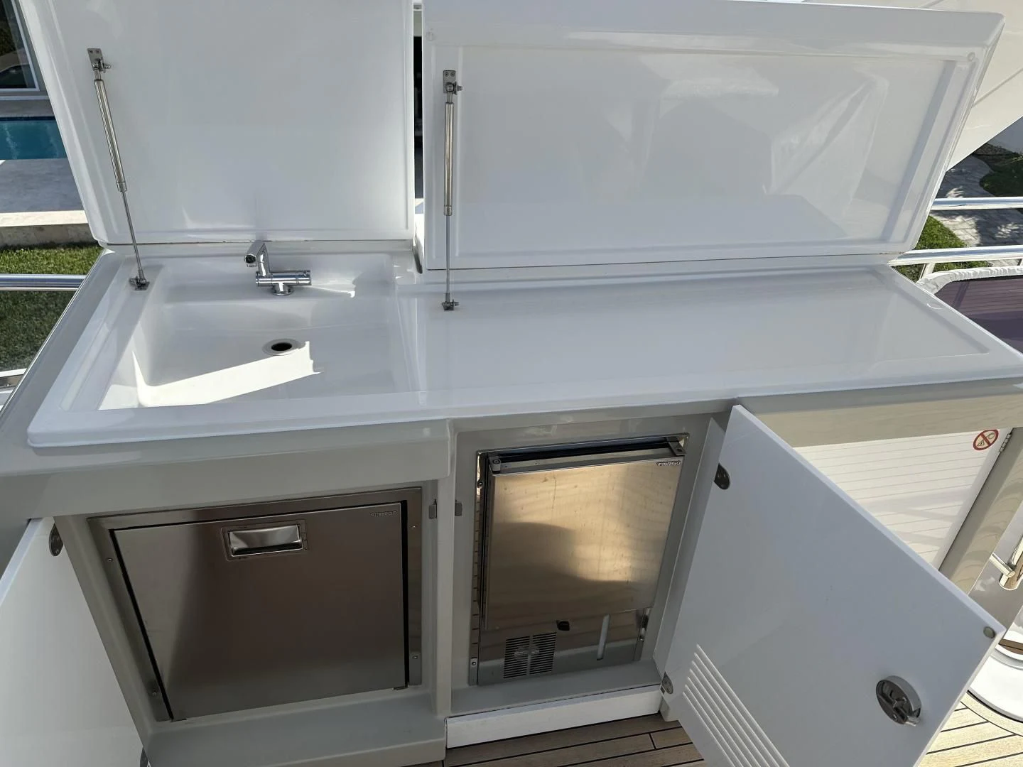 a white kitchen with a sink aboard VELOCITY Yacht for Sale