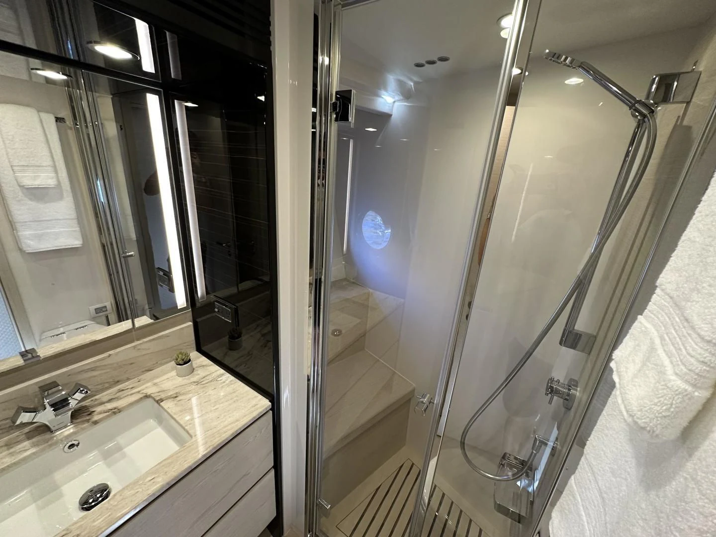 a bathroom with a glass shower aboard VELOCITY Yacht for Sale