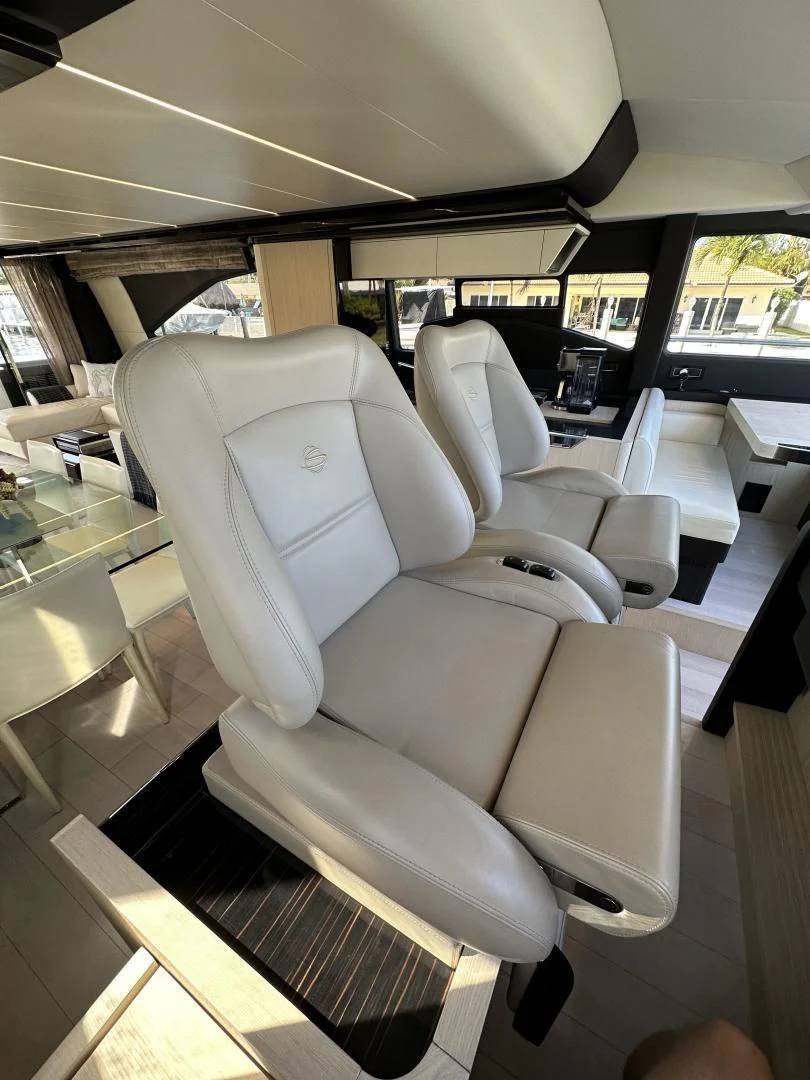 a room with chairs and tables aboard VELOCITY Yacht for Sale