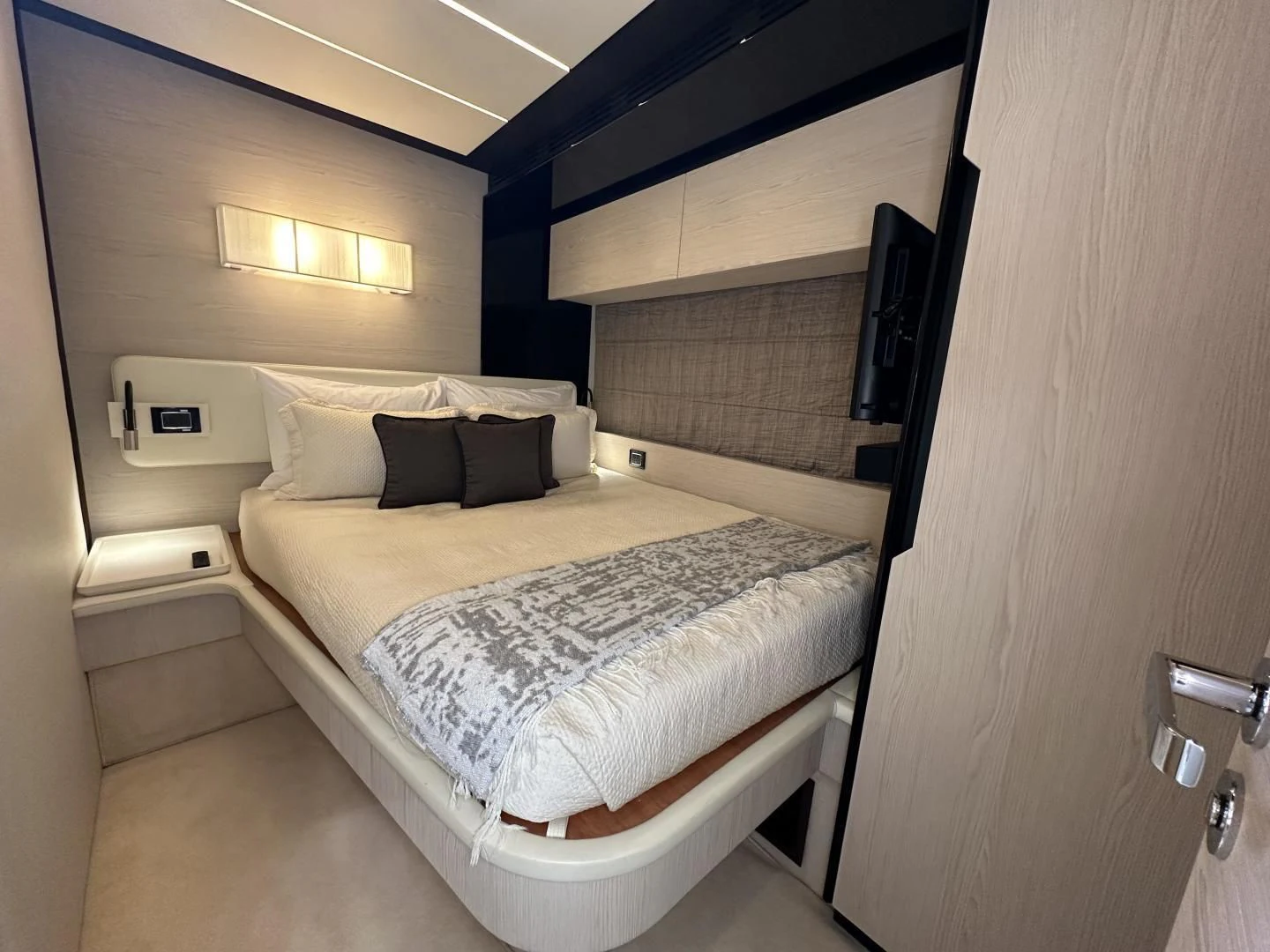 a room with a bed and a television aboard VELOCITY Yacht for Sale