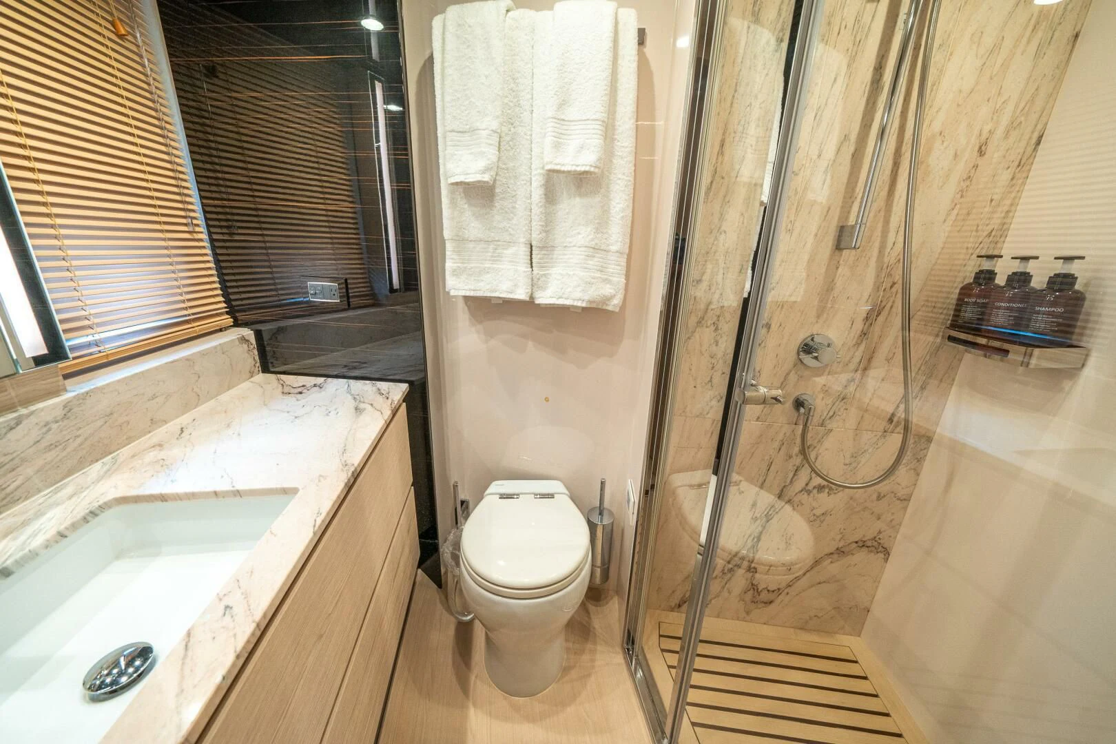 a bathroom with a toilet and sink aboard VELOCITY Yacht for Sale