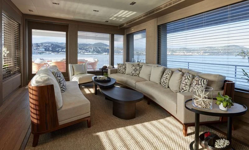 a living room with a couch and a table aboard QUINTET Yacht for Sale
