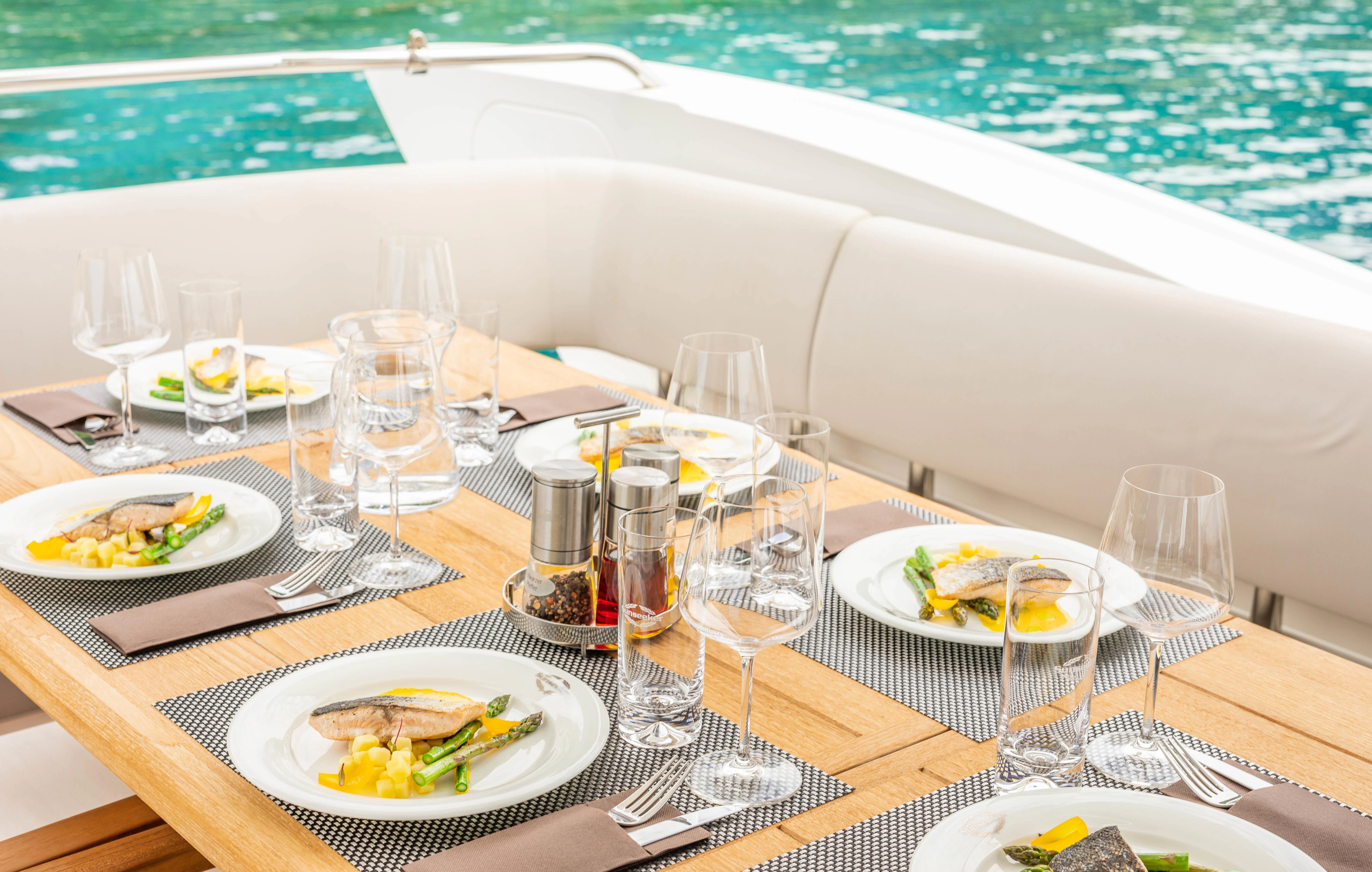 a table with plates and glasses on it aboard HIDEAWAY Yacht for Charter